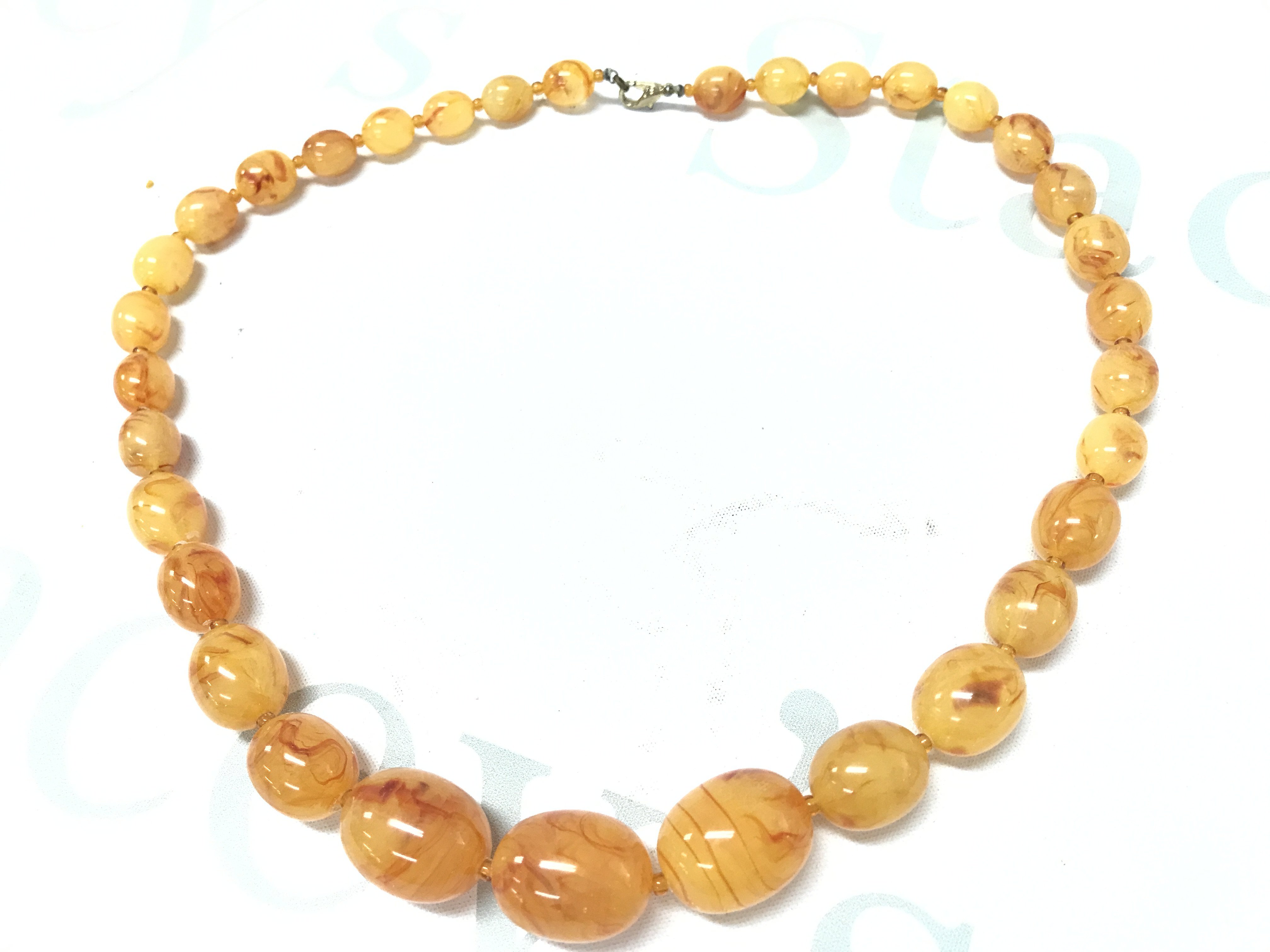 A butterscotch amber necklace , 70g , 63cm . Postage category A