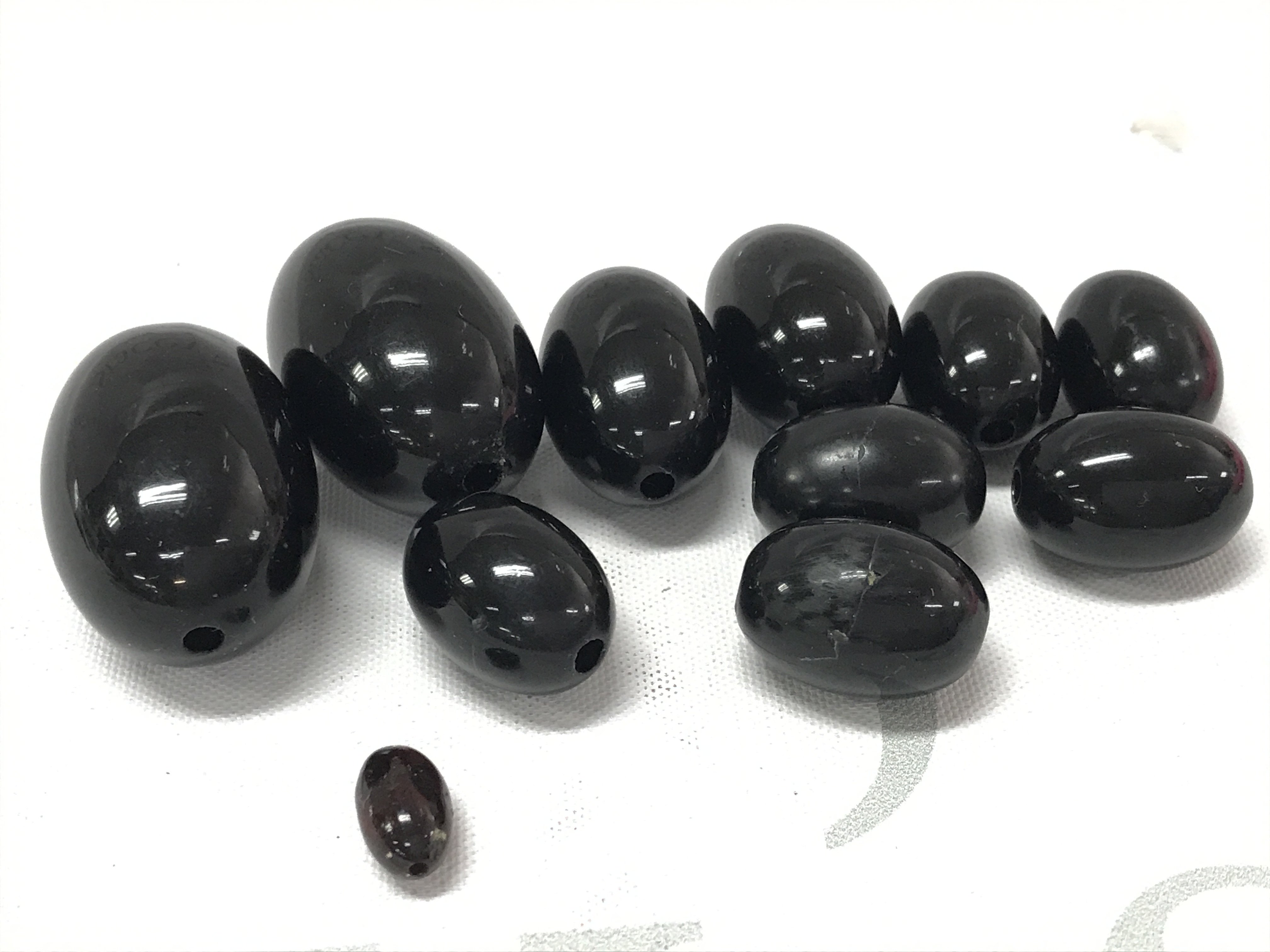 Very rare cherry red black amber 11 beads, total weight 40g largest bead 32mmx21mm. Postage category A