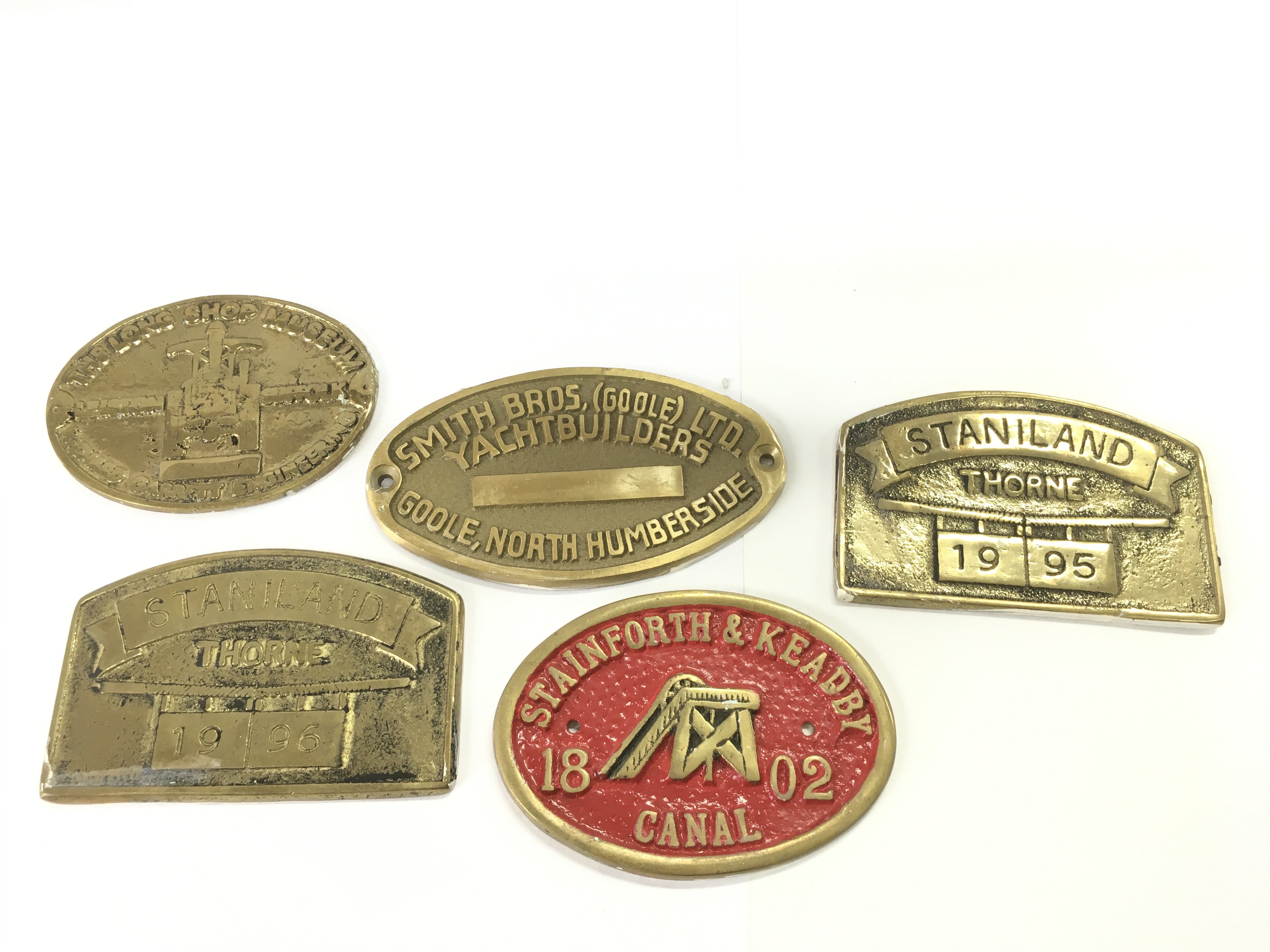 A group of brass plaques from various firms including yacht builders and others. Postage B