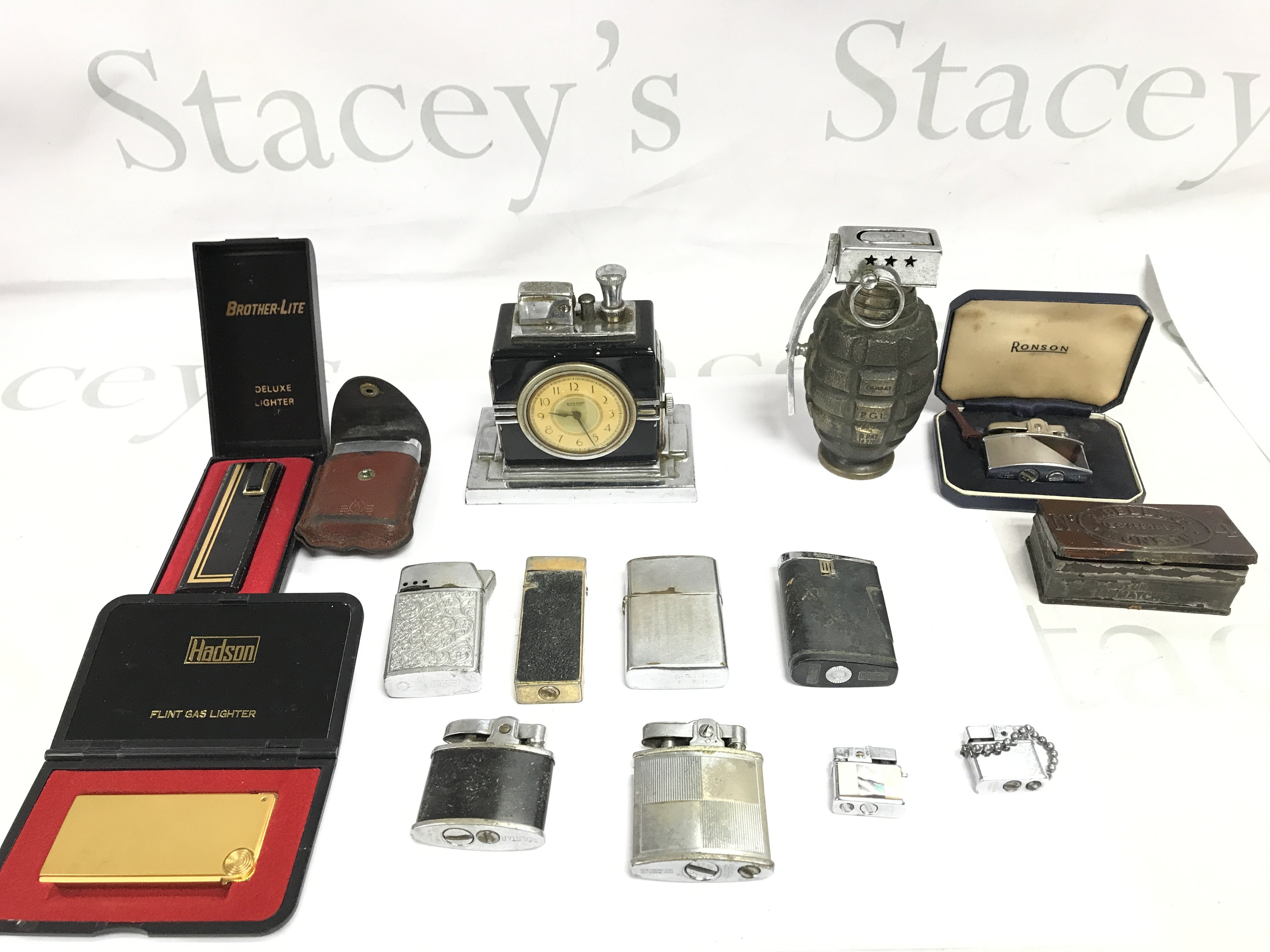 A collection of assorted lighters including a Ronson clock desk lighter. Postage B