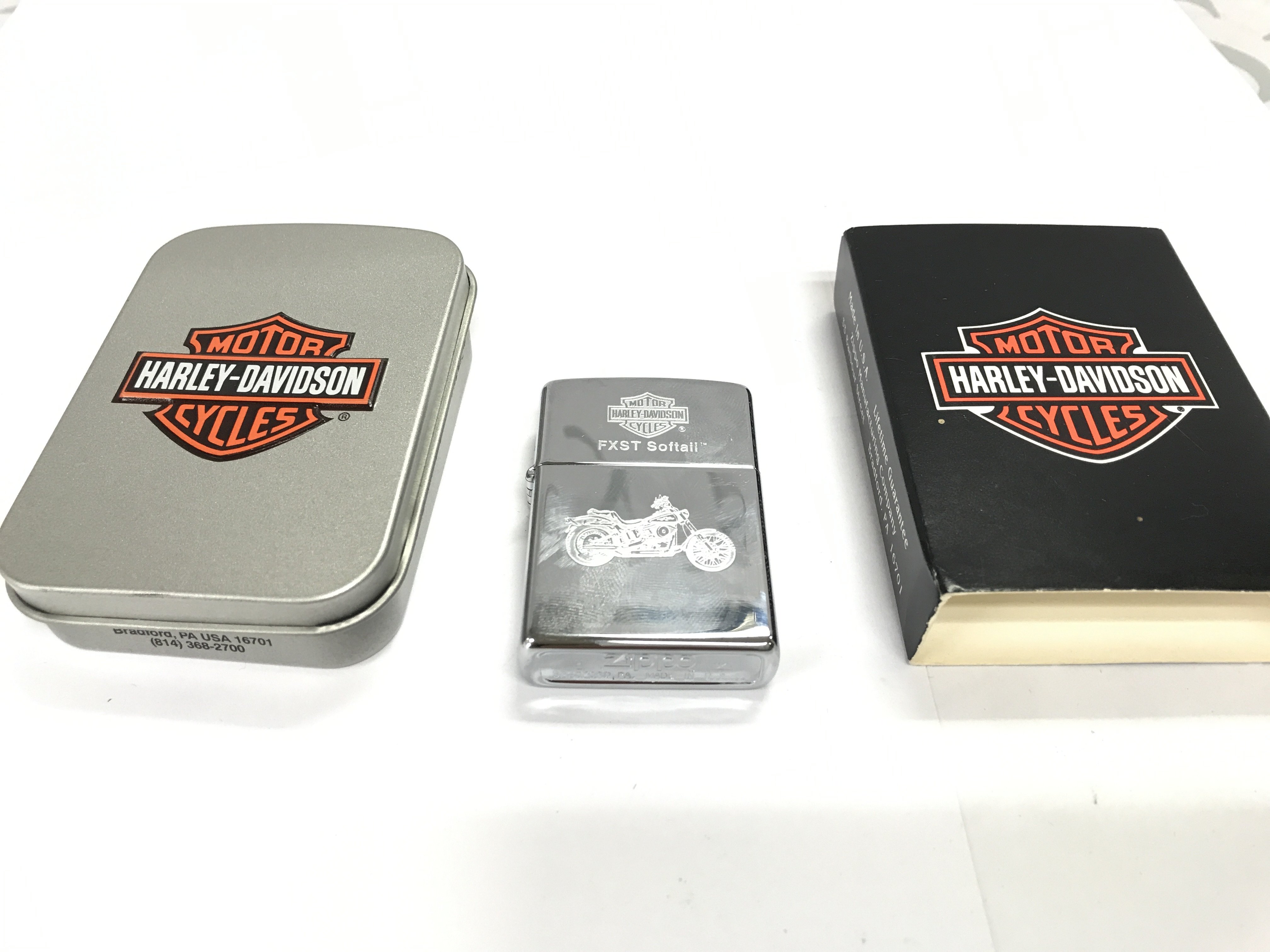 A Harley Davidson FXST softail zippo lighter with packaging in excellent condition. Postage A