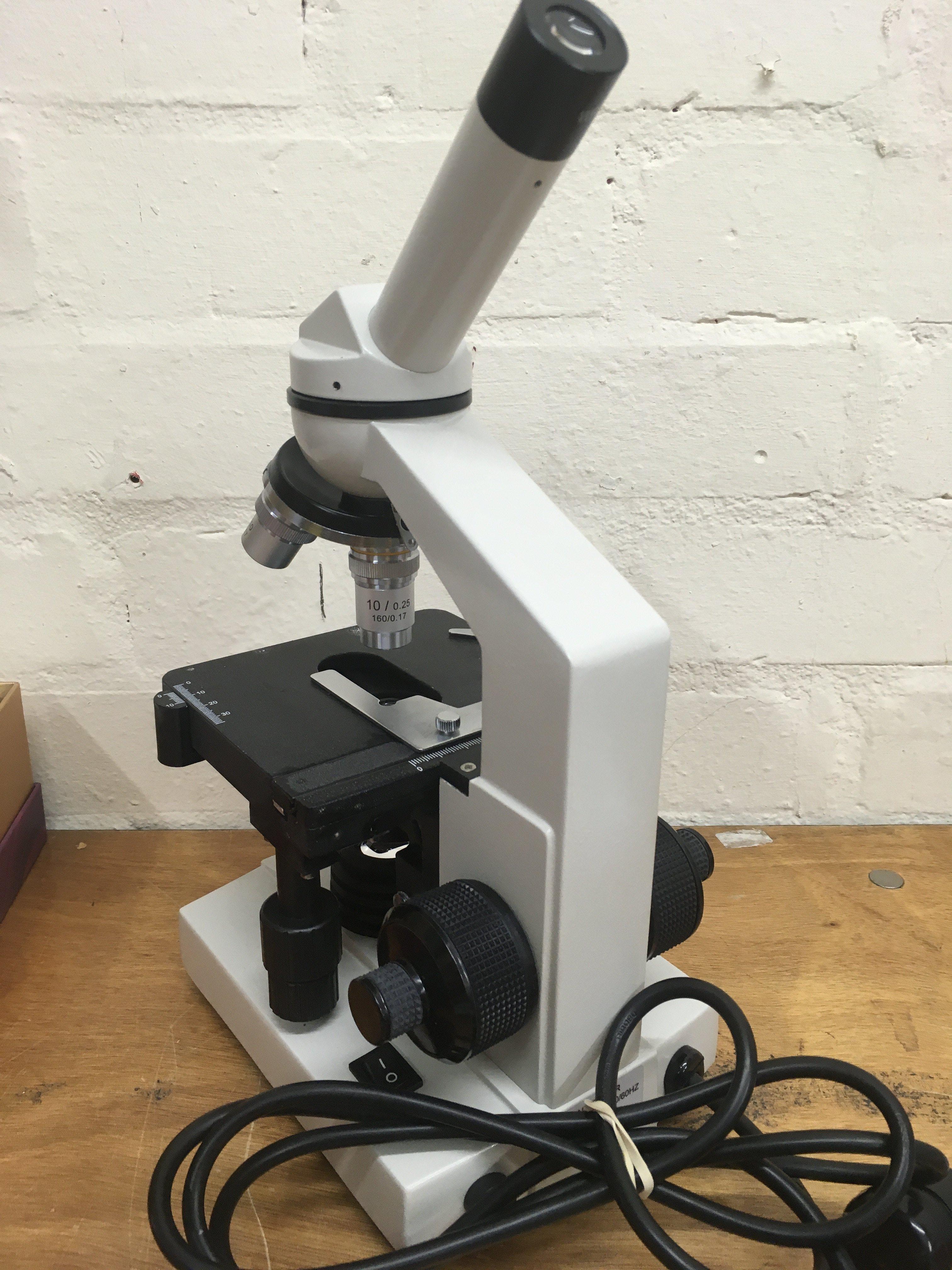An Apex Practitioner Microscope. Postage category C- NO RESERVE