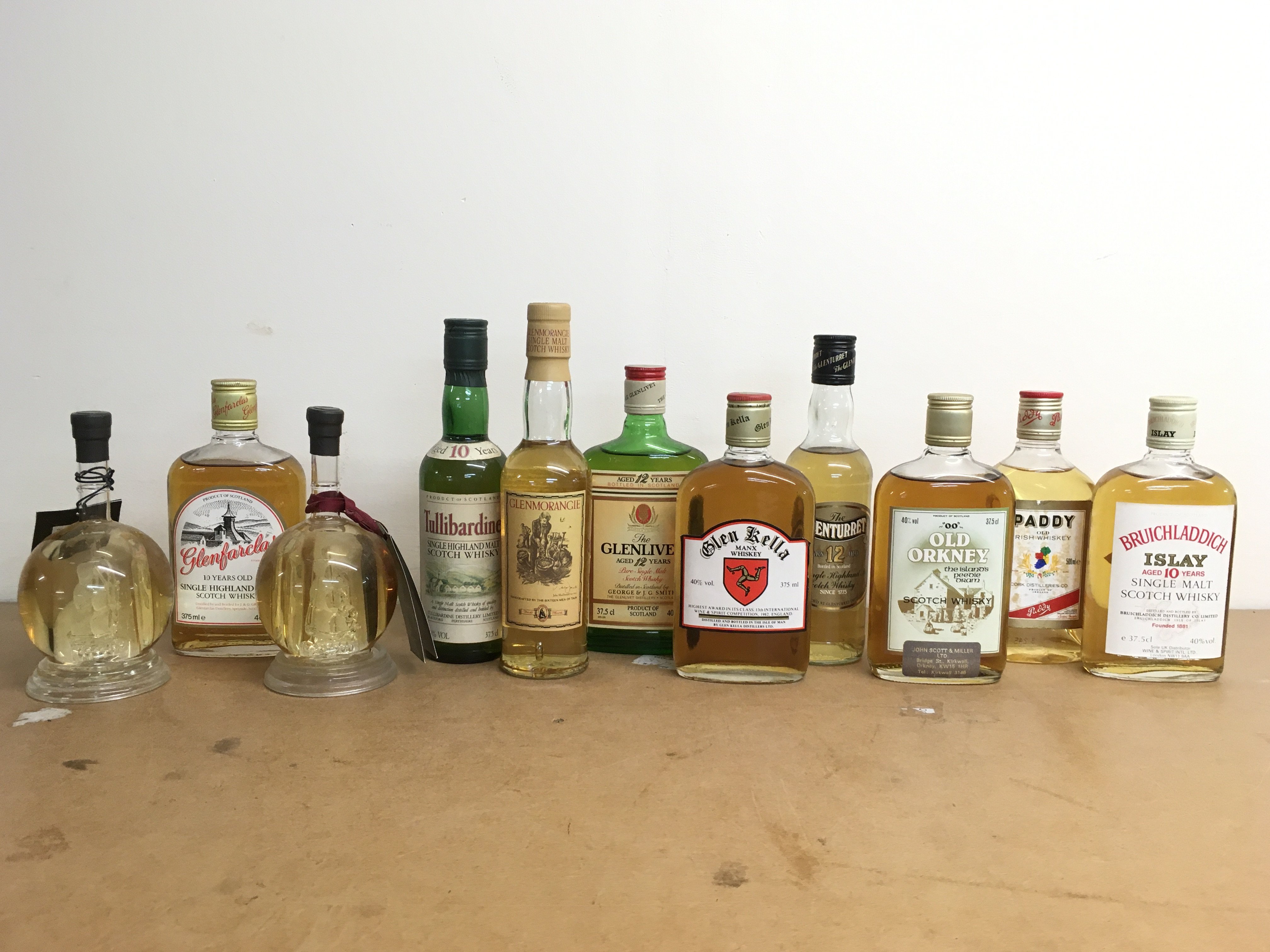 Whiskeys including Bruichladdich Islam 10 year single malt scotch , Old Orkney scotch, Glenturret 12 years , Glen Kella Manx whiskey, Glenlivet 12 years, Glenmorangie, Tullibradine, Glenfarclas. This lot cannot be posted