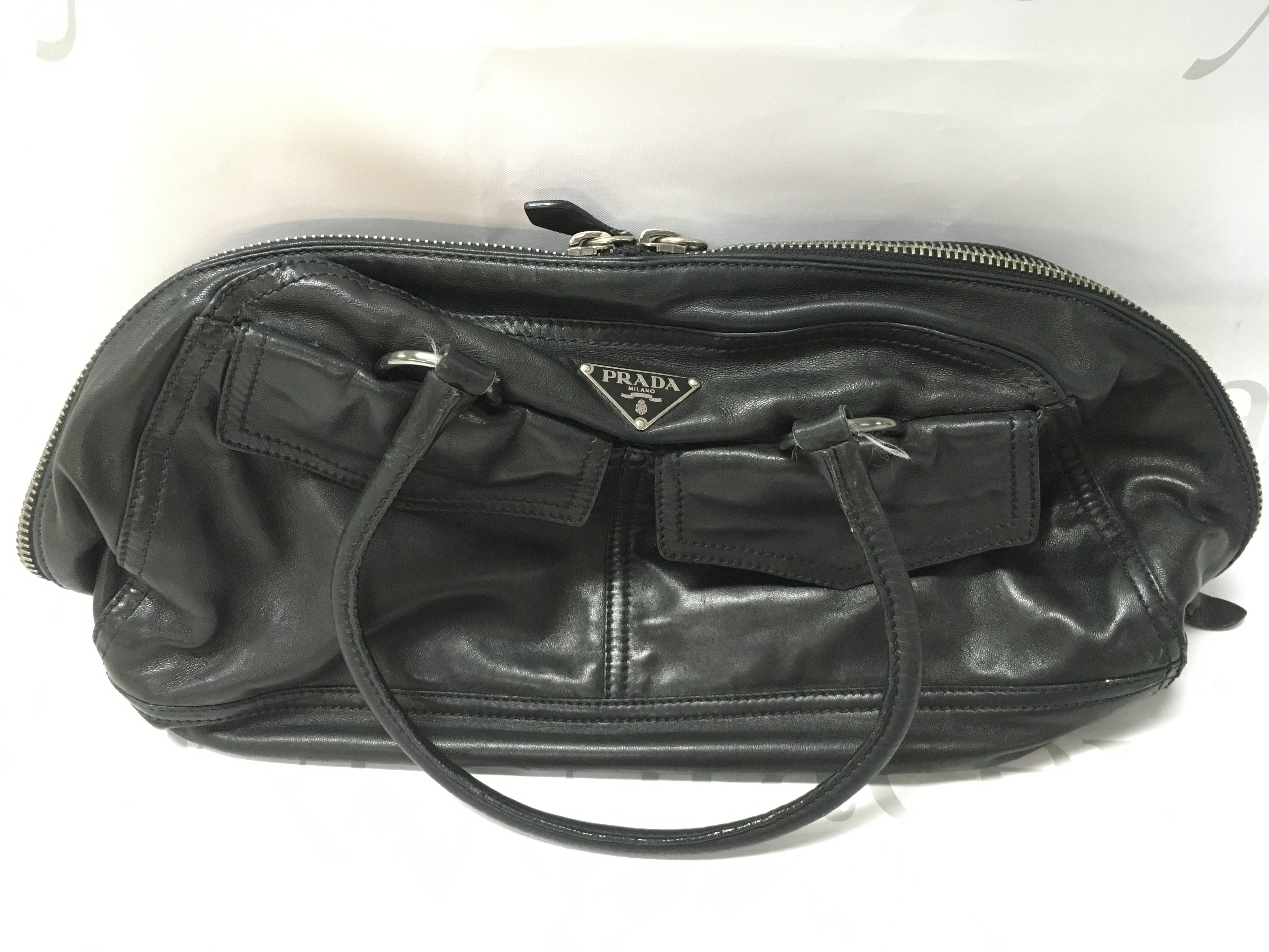 A black leather Prada bowler handbag , postage category C