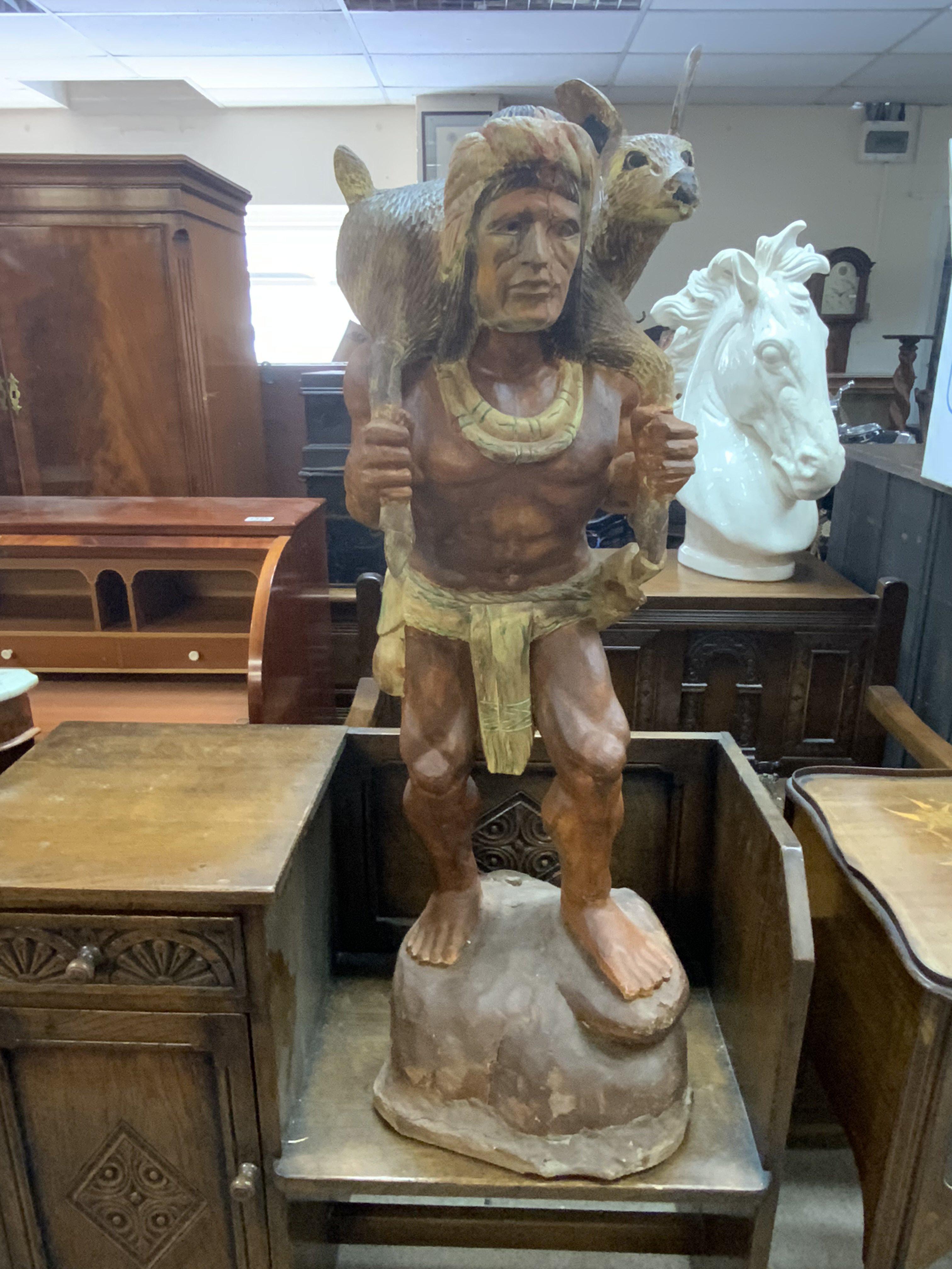 A caved hunter figure, teak and gesso. 105cm