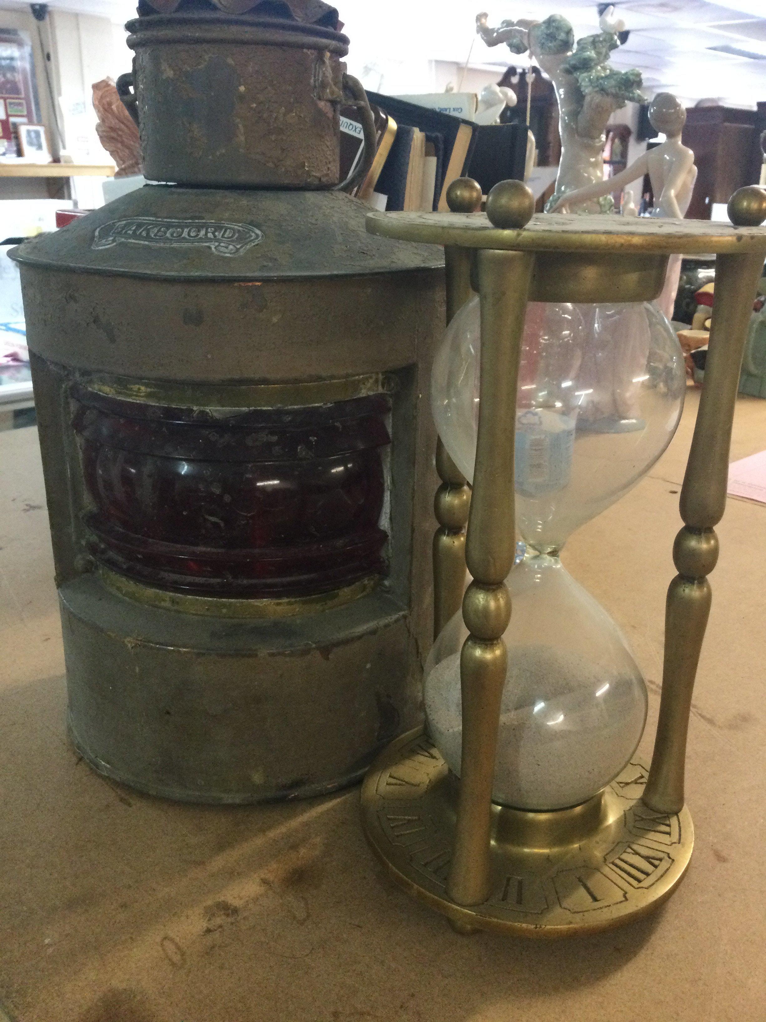 A time glass together with a ships lamp .