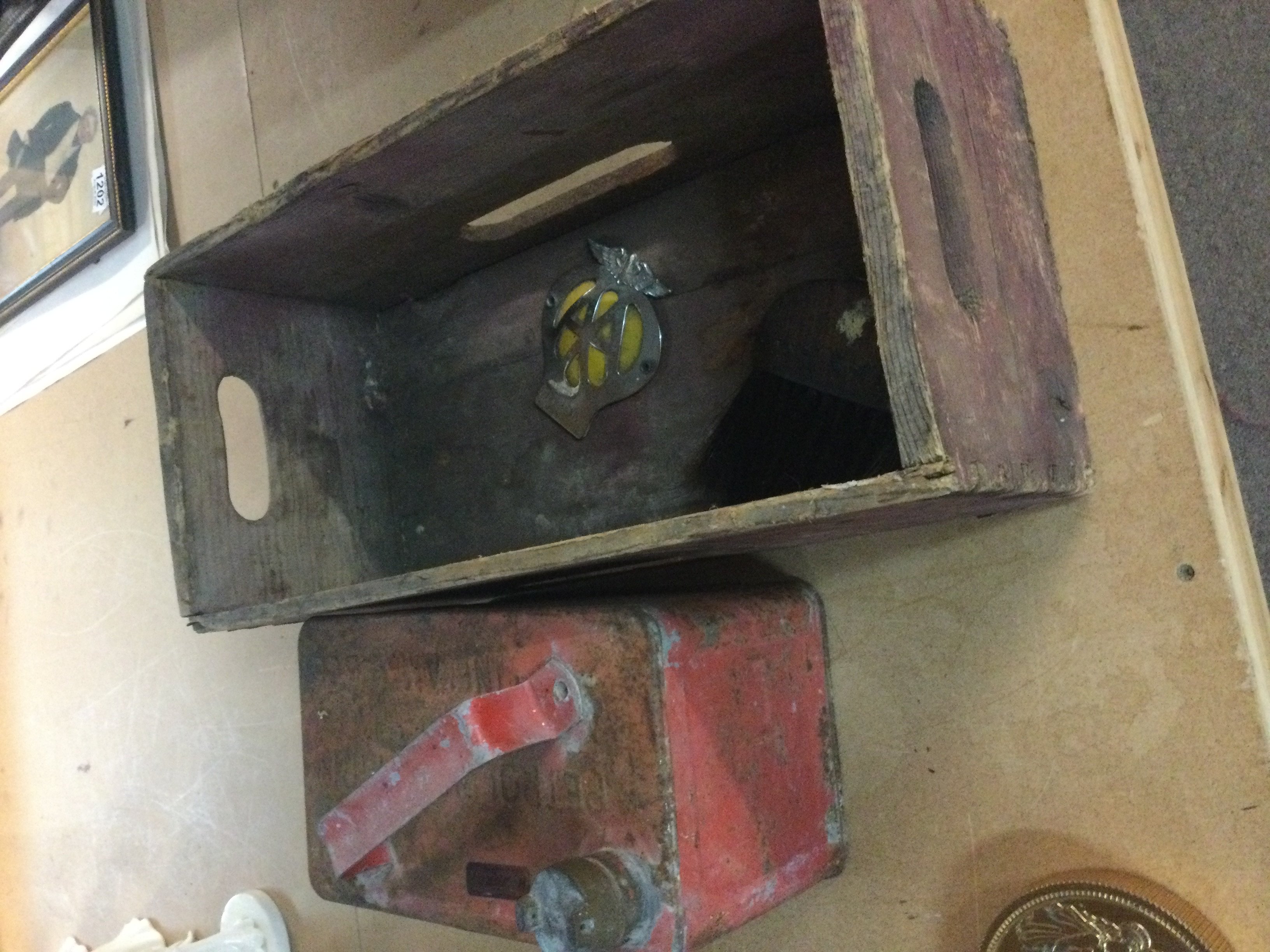 A Schweppes box together with a petrol can .