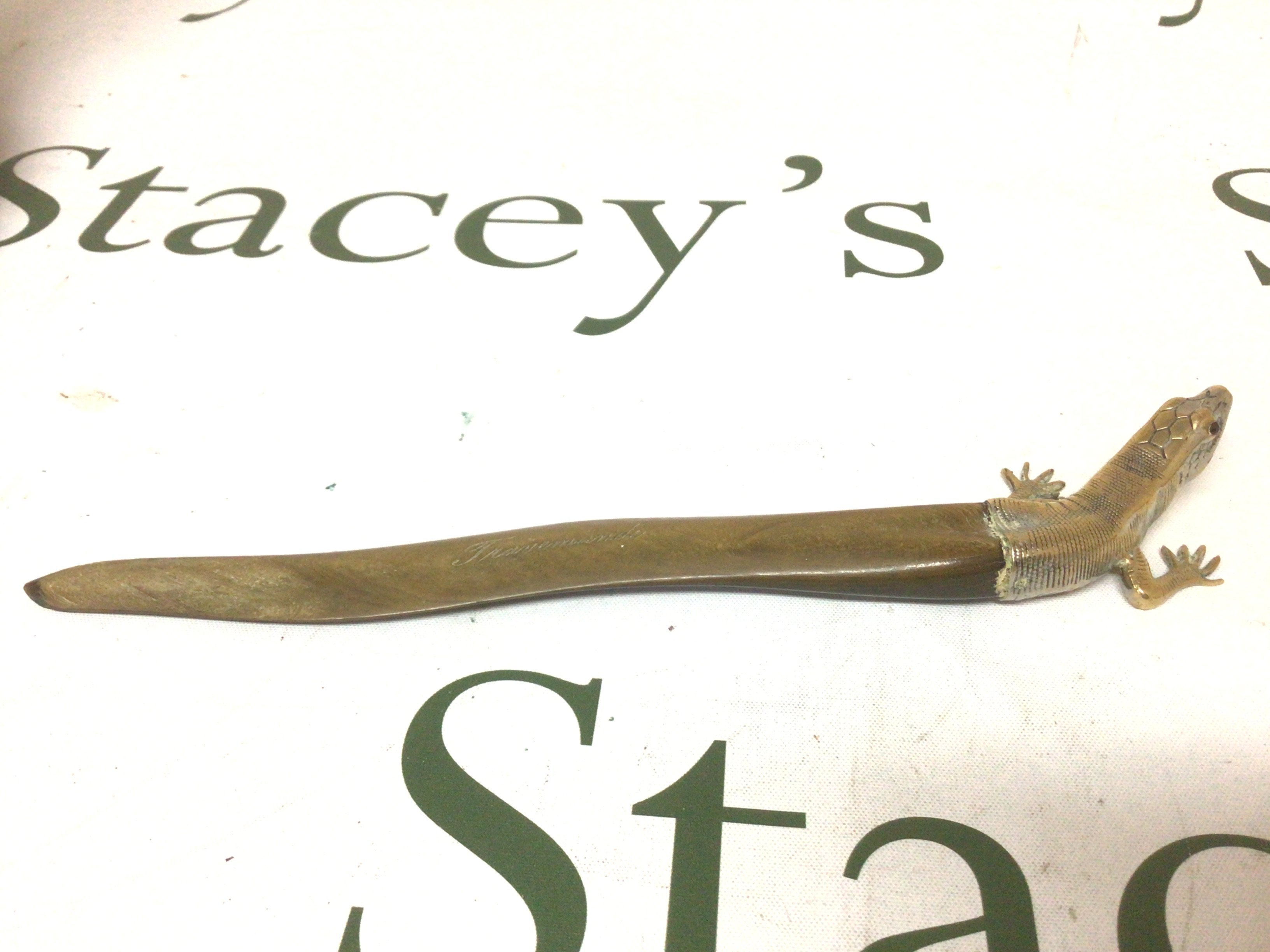 An Antique paper Knife with a shaped horn blade the end in the form of a lizard made in brass.