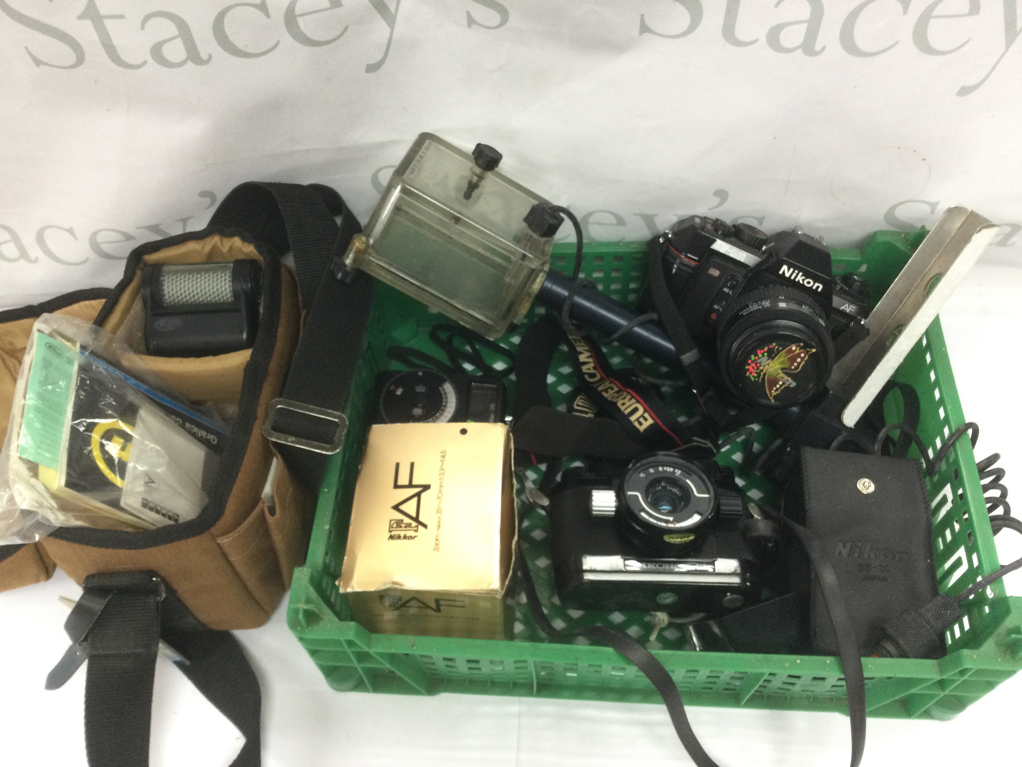 A small collection of cameras and accessories including a Nikon F-501. Shipping category D.