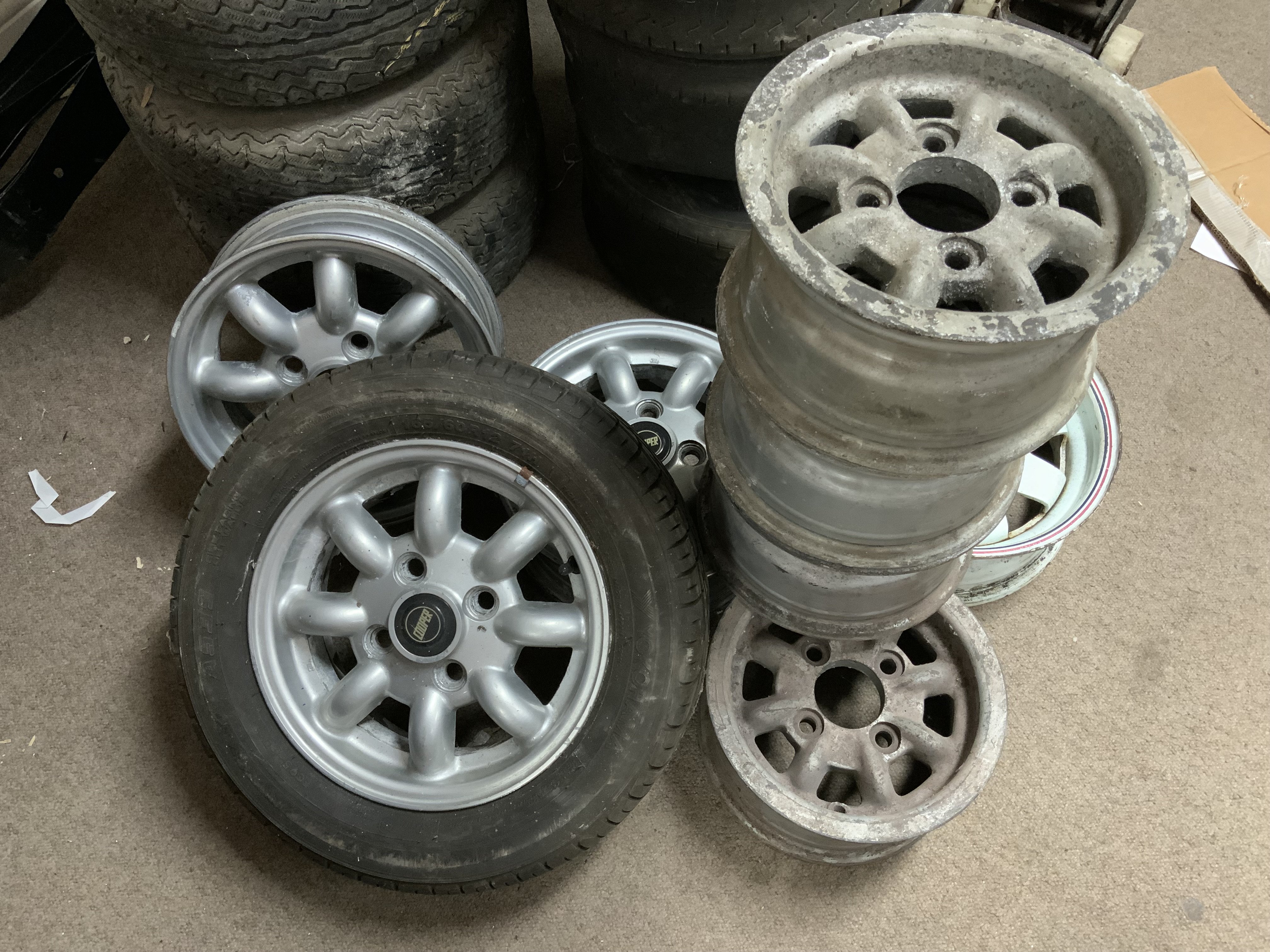 Vintage Mini Cooper parts. 4 Alloy wheels 28cm diameter, 1 Enamelled steel wheel 33cm diameter, 3 alloy wheels 33cm diameter.