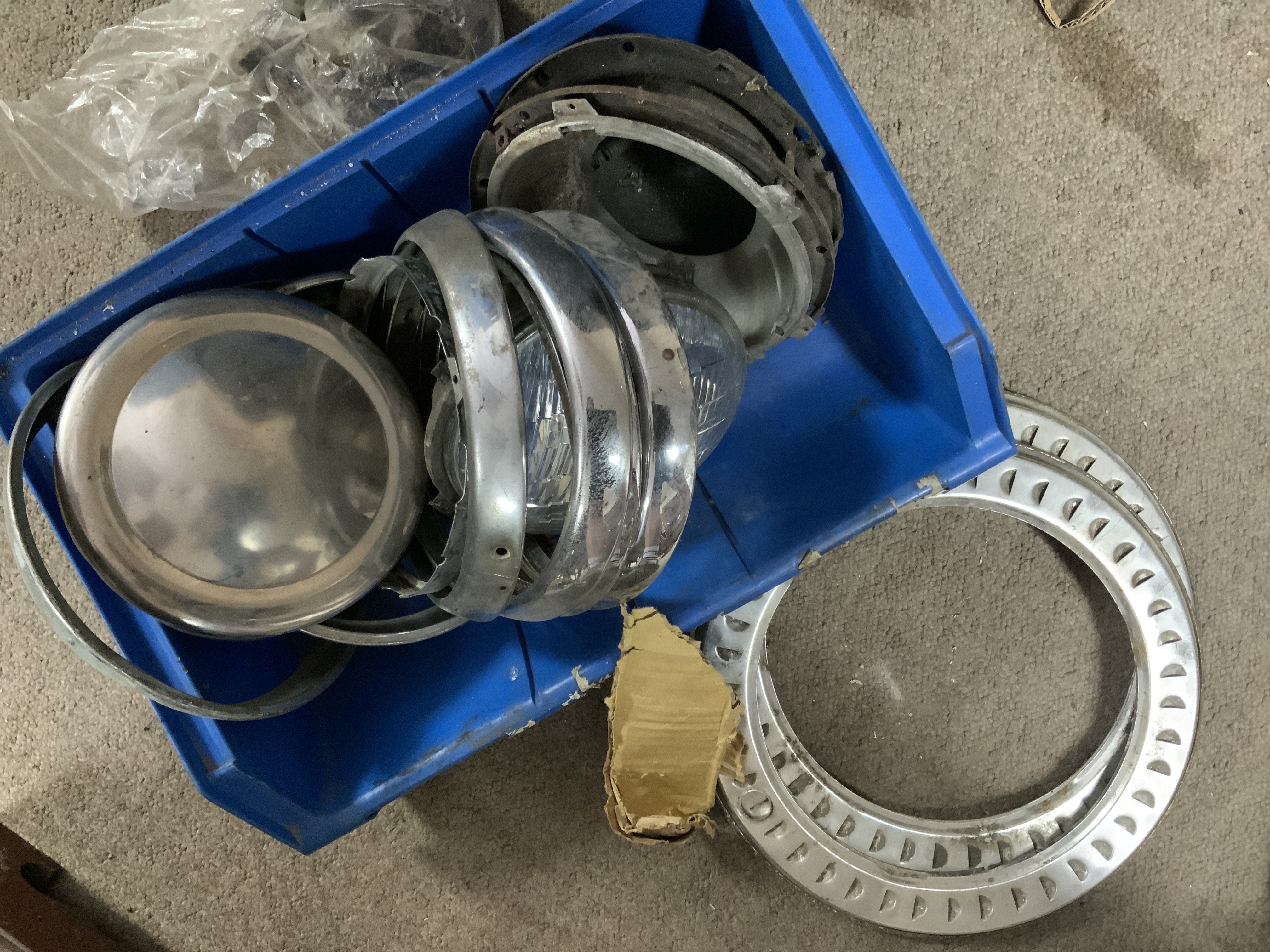 Vintage Mini Cooper parts. A large collection of chrome light mounts, Lights, chrome trims, and other body accessories.