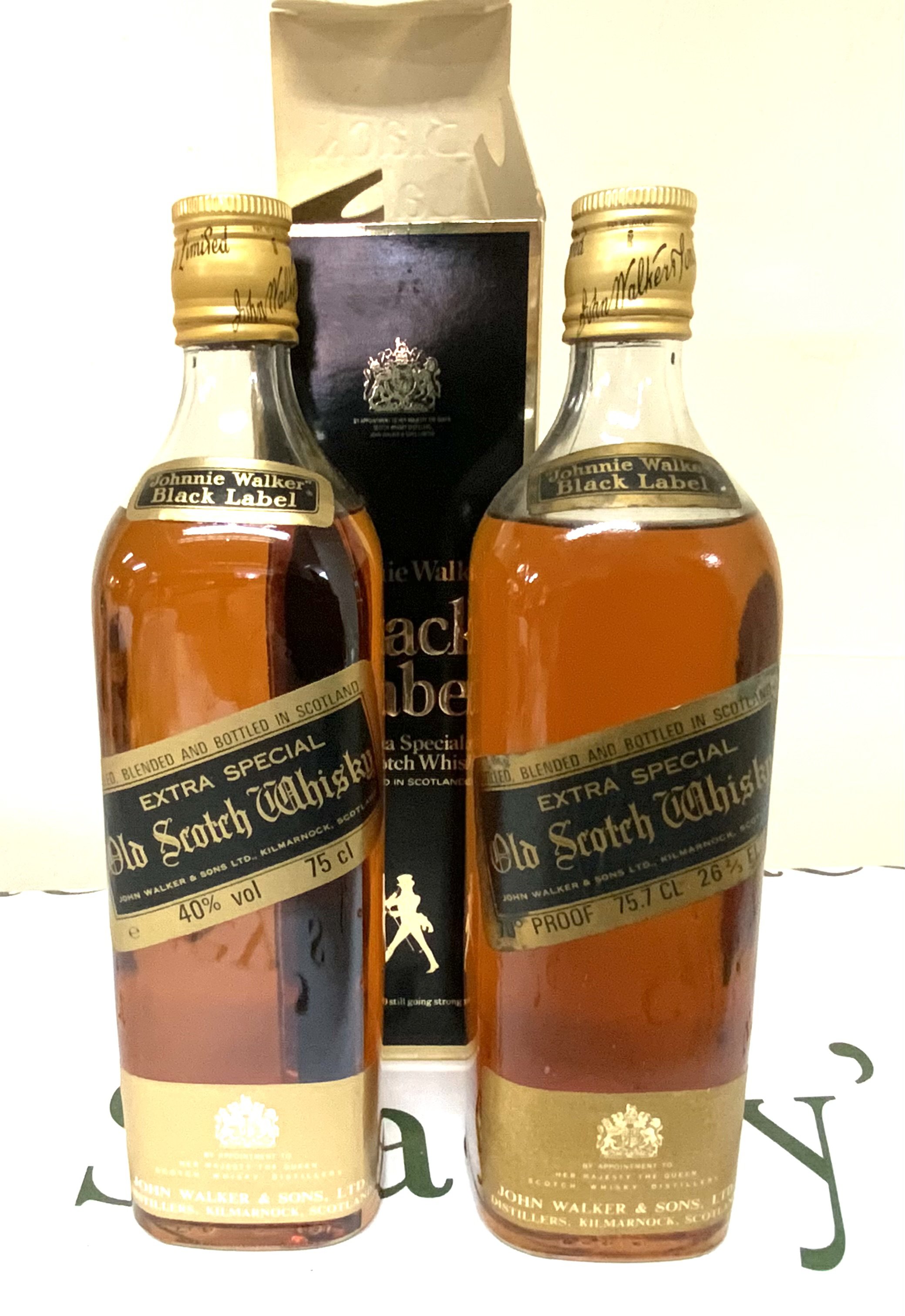 A vintage bottle of Johnnie Walker Black label together with a modern issue with box.