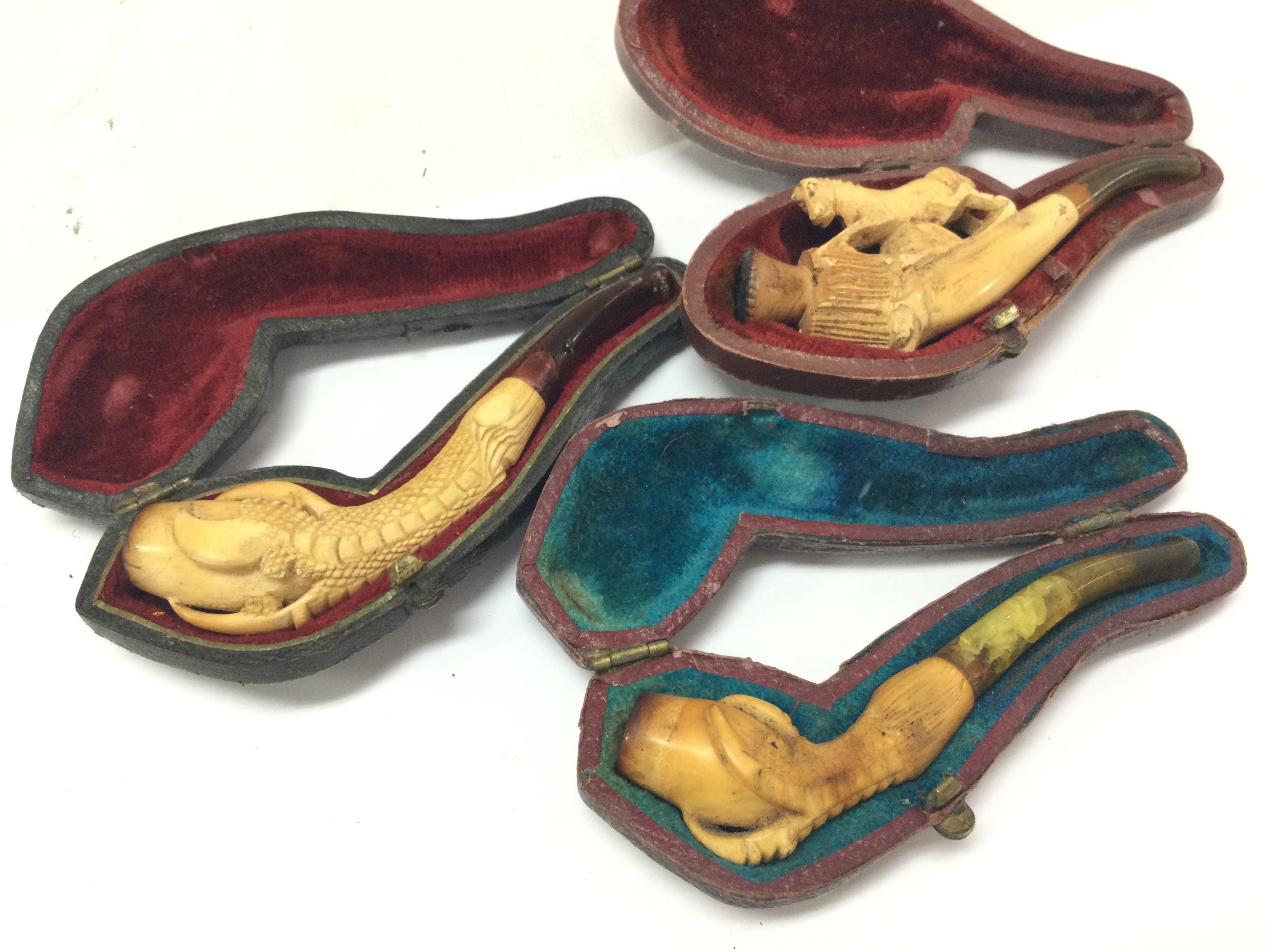 Three Victorian small meerschaum pipes carved and in original cases