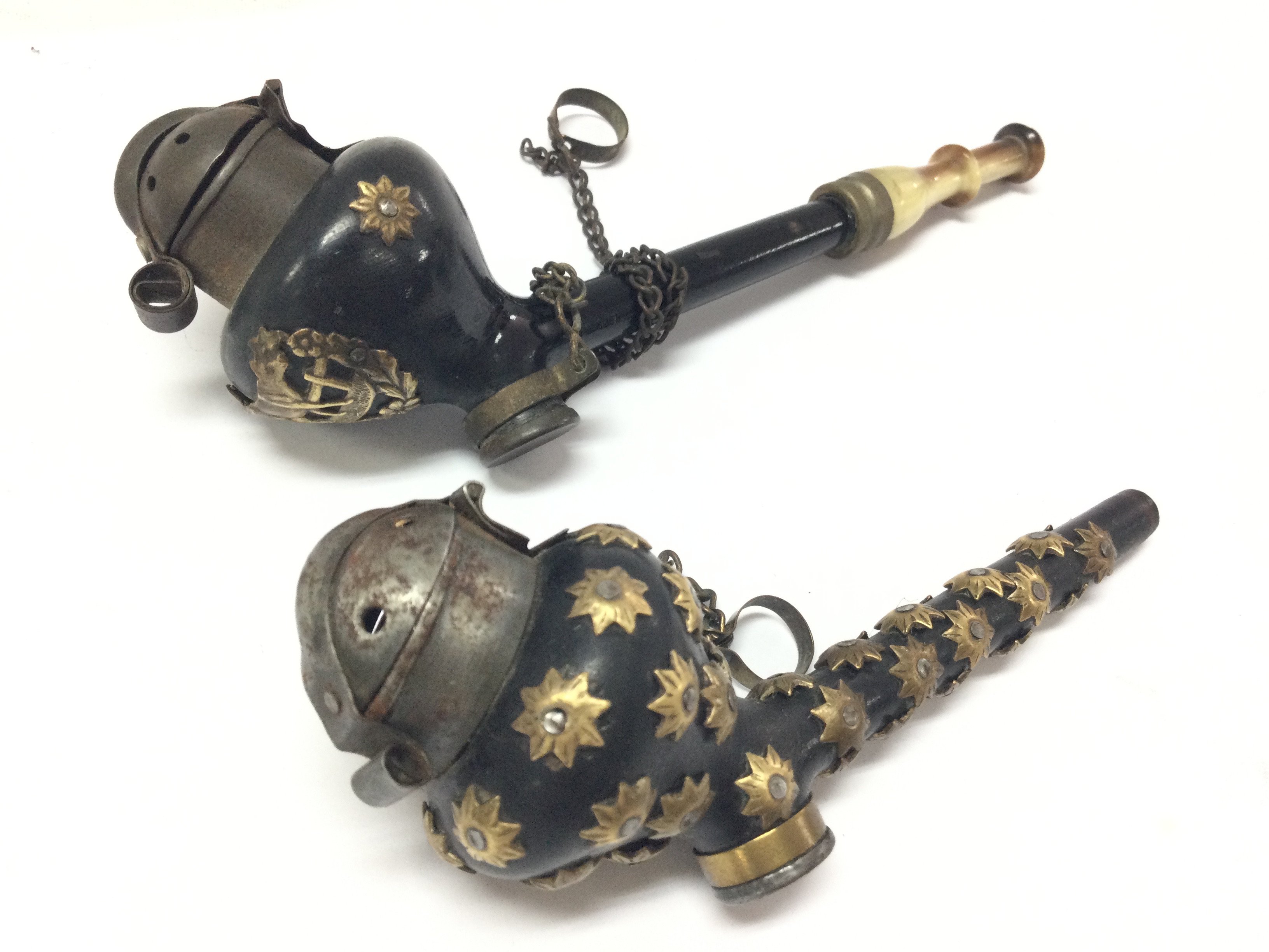 Two small Victorian smoking pipes, one decorated with brass stars and the other a small brass cow . 14 and 11cm long. Postage category A
