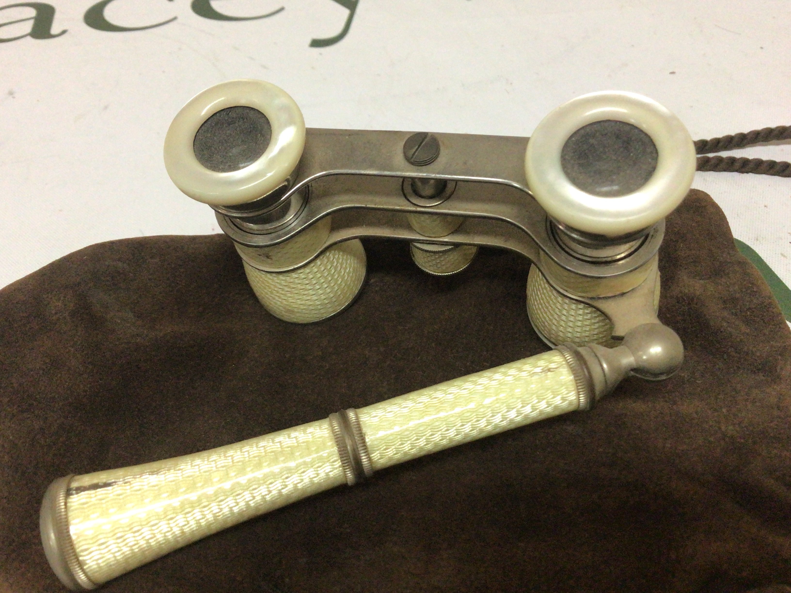 A pair of yellow enamelled Opera glasses some minor damage. Makers marks DRGM.