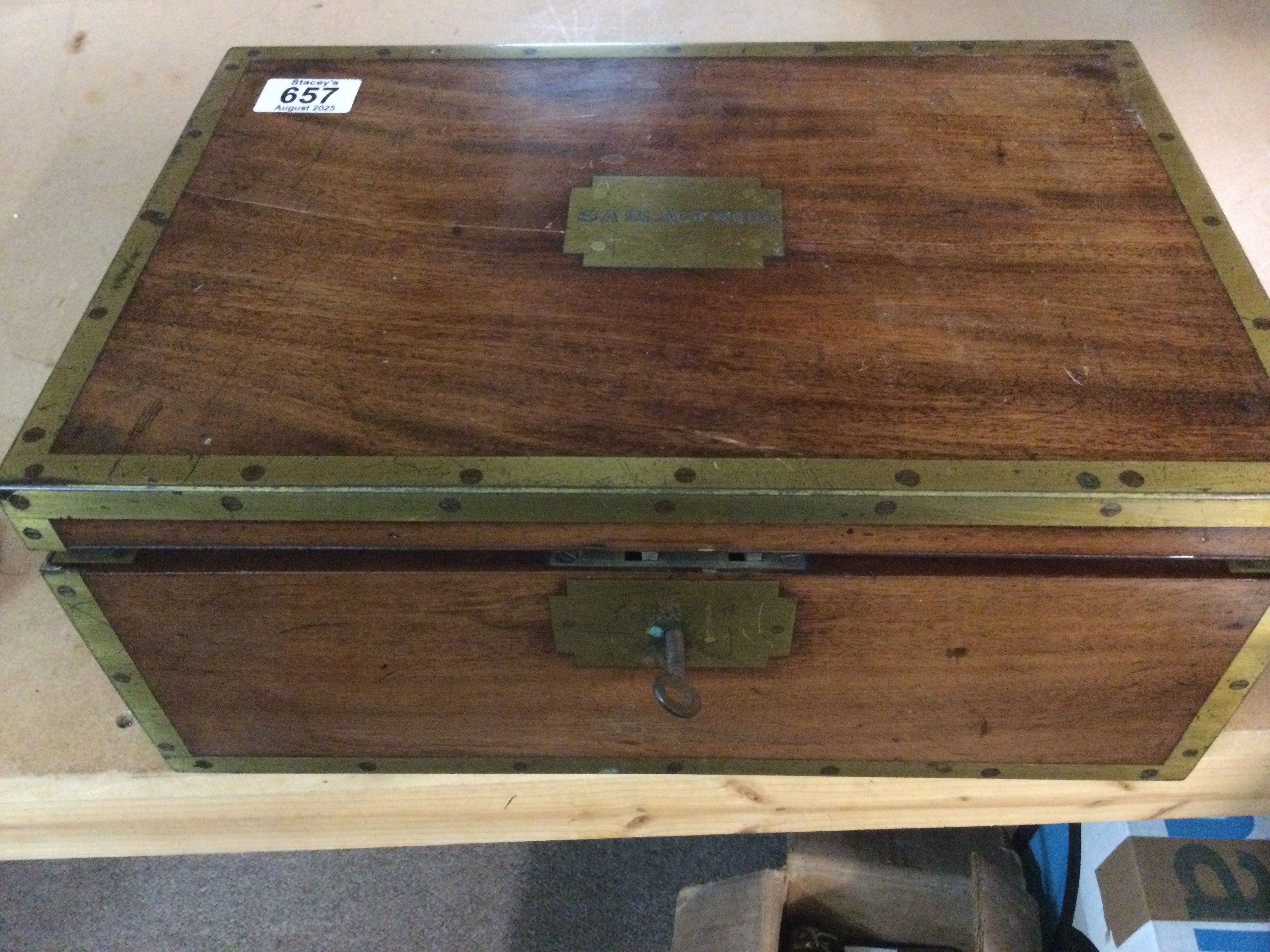 A mahogany campaign brass bound writing slope with a fitted interior.