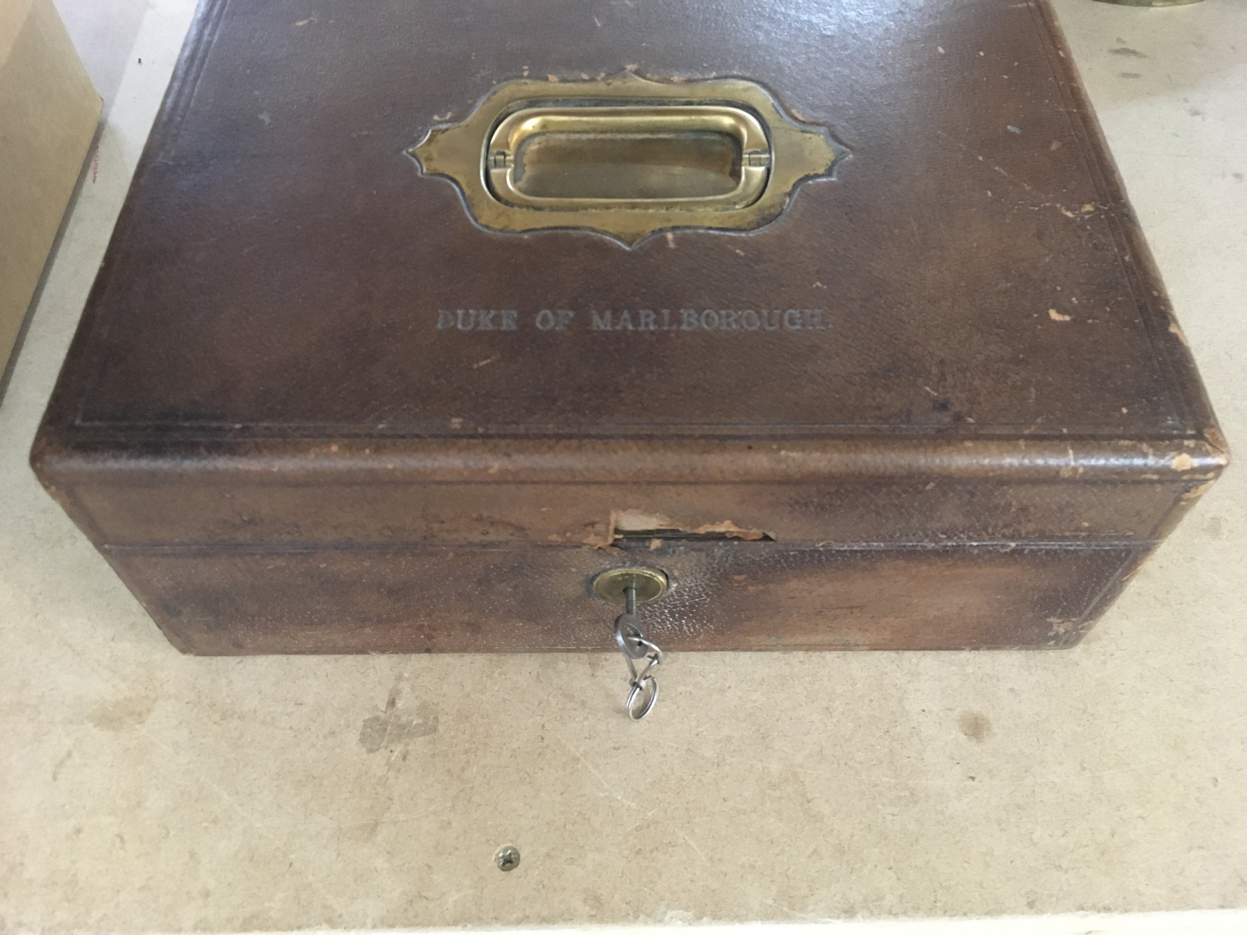 A Churchill family leather and brass cigar box the hinge lid impressed With The Duke of Marlborough inset with a detector action Chubb lock .