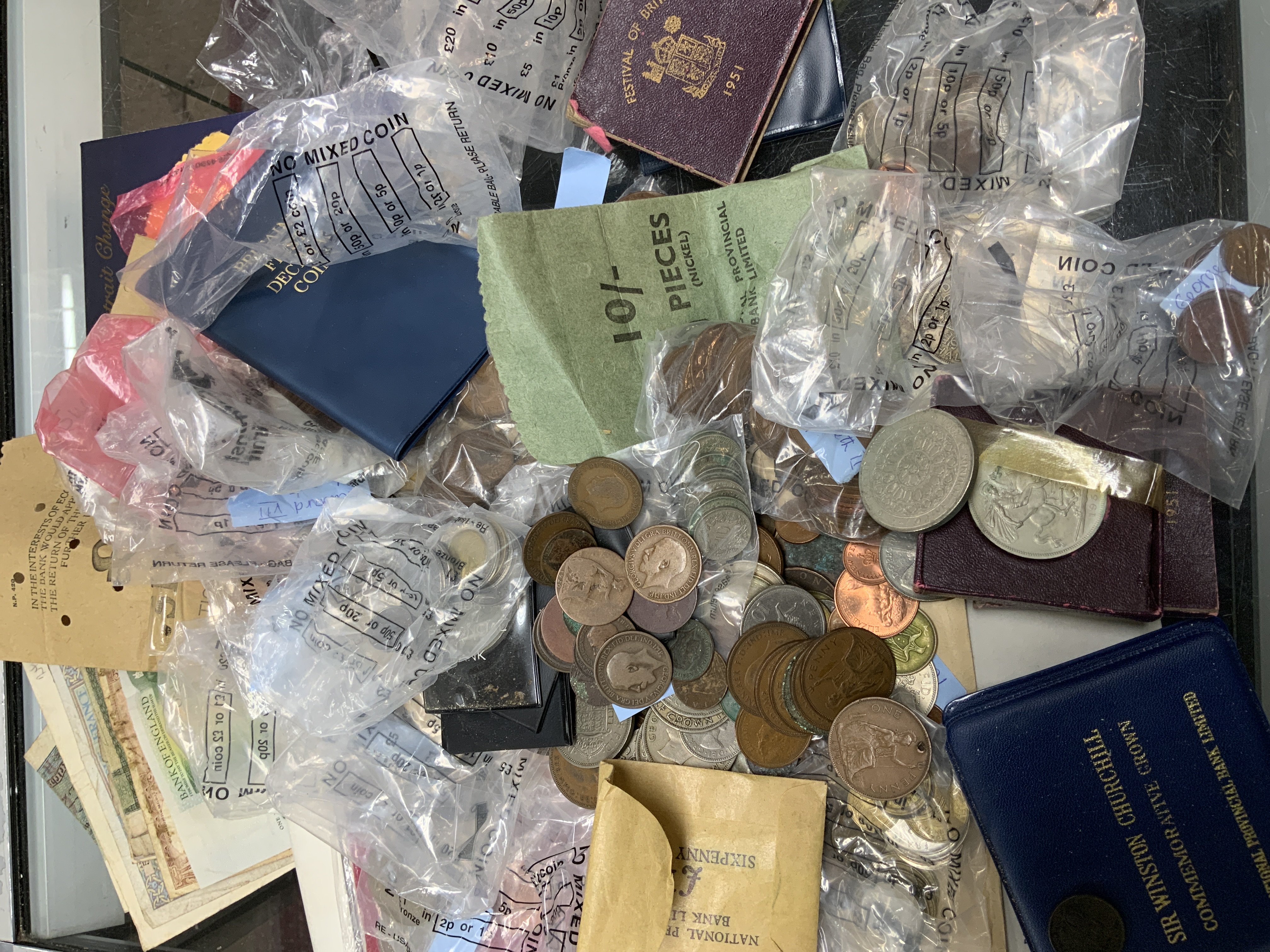 A mixed collection of British coins and banknotes.