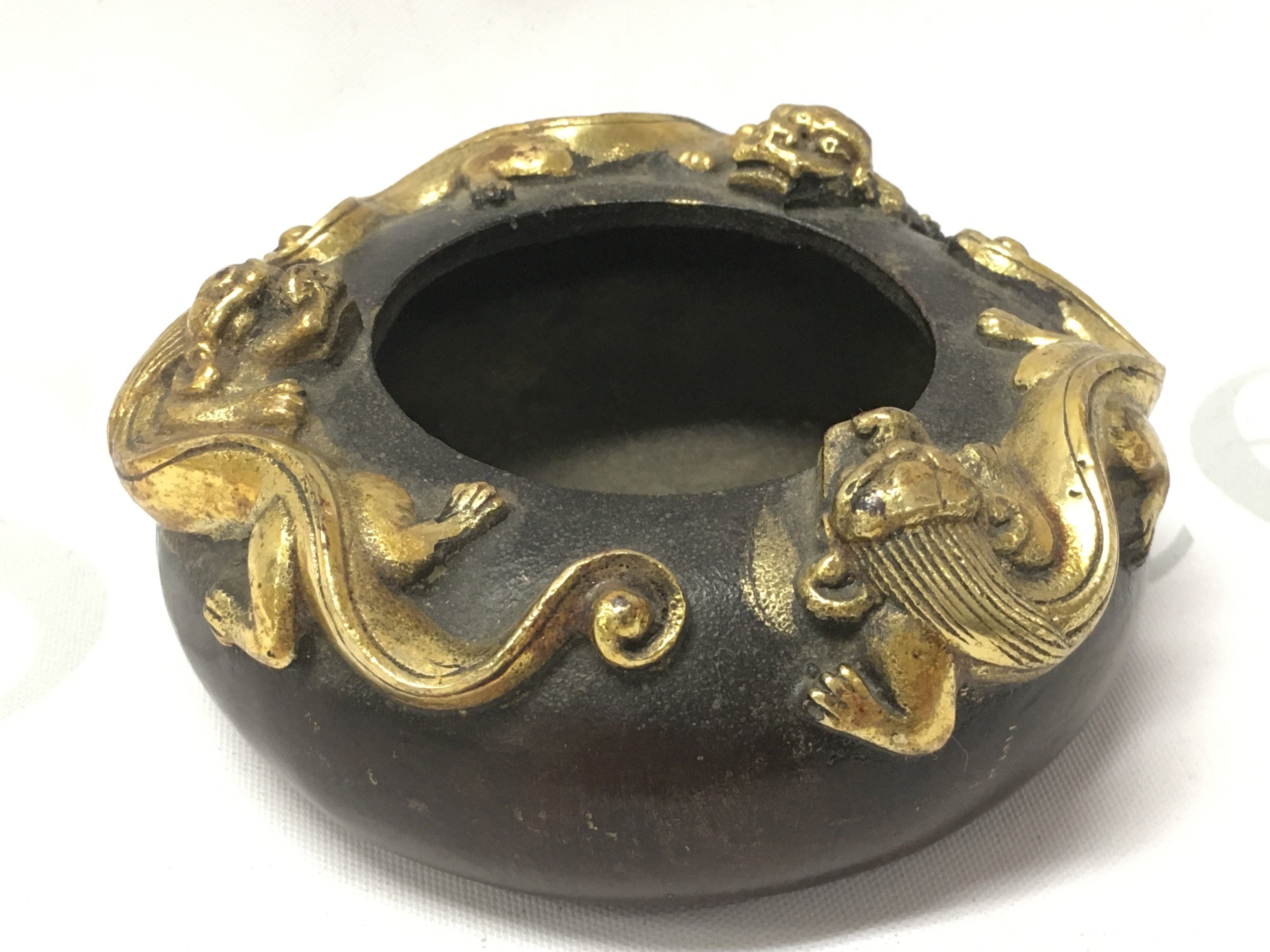 A Chinese three gilt dragon bronze censor with a four character mark at base. 4cm tall 9cm wide. Postage category A