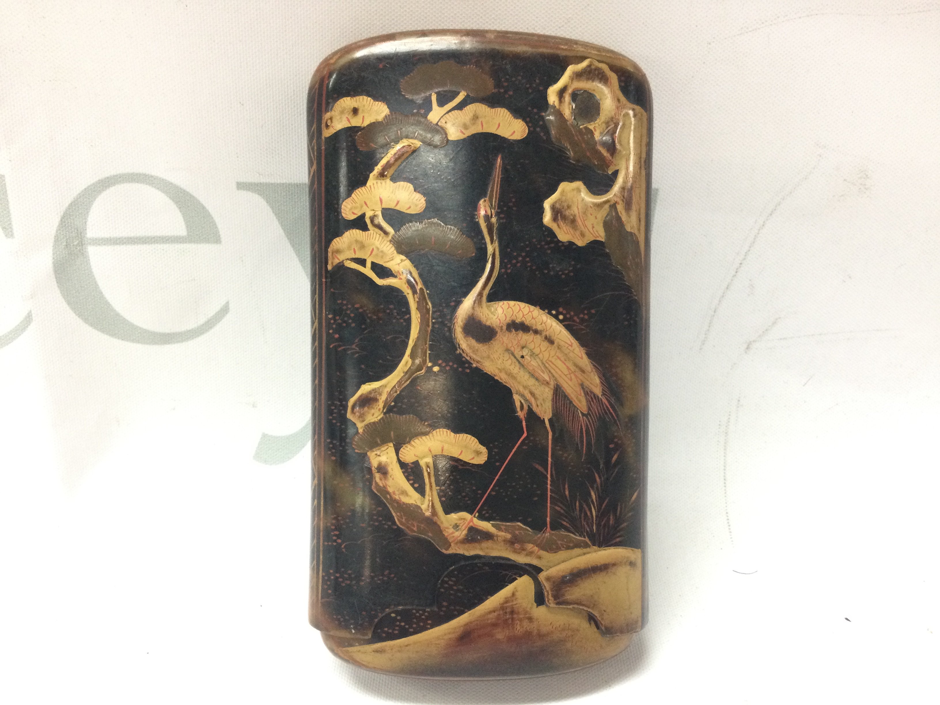 A Japanese tortoiseshell cigar case with embossed decorated giltwork and orient animal design. 12cm tall. Postage category B