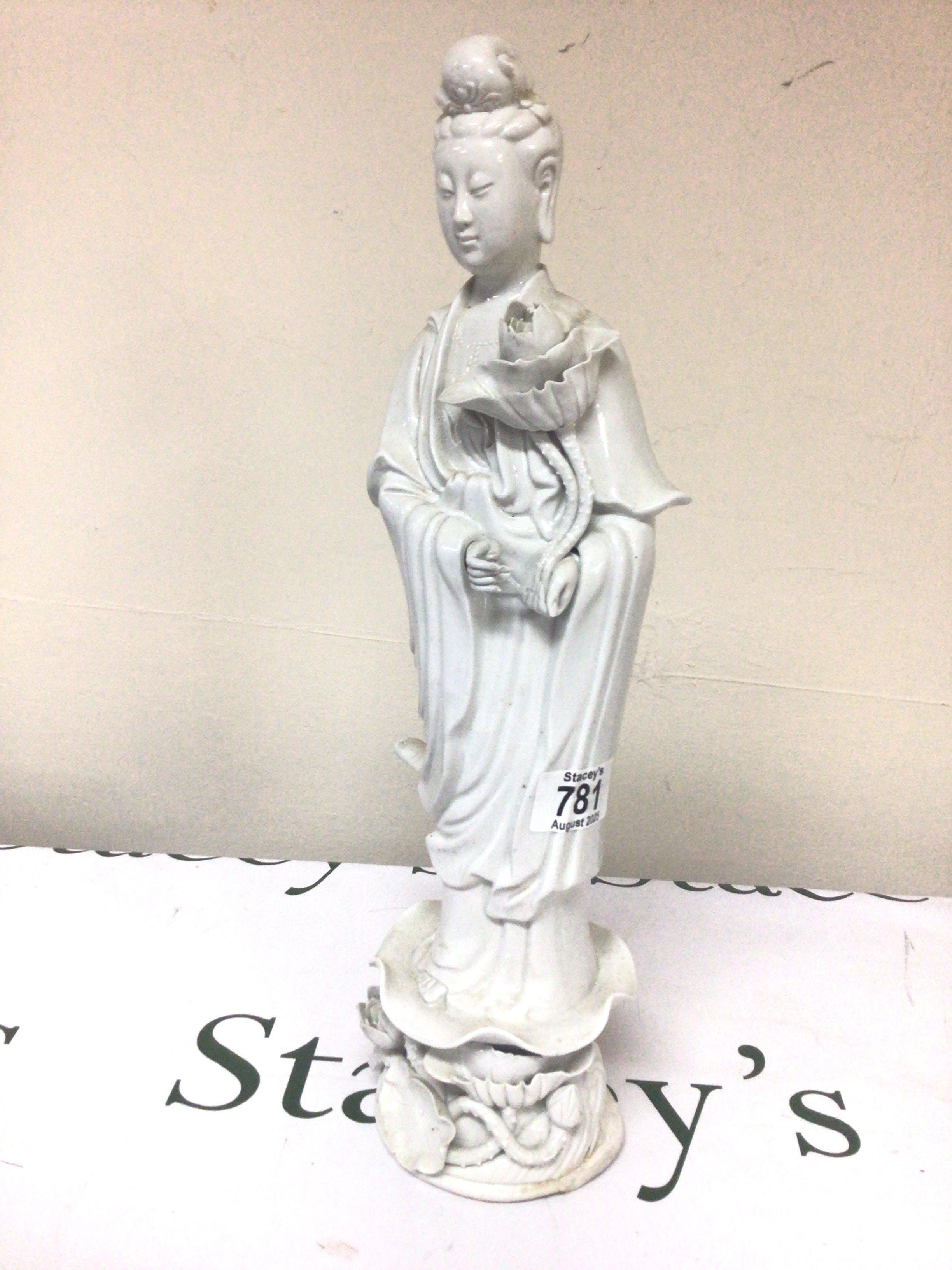 A Chinese blanc de chine Porcelain figure of Guan Yin the goddess of Mercy damage to the base. Height 41cm.