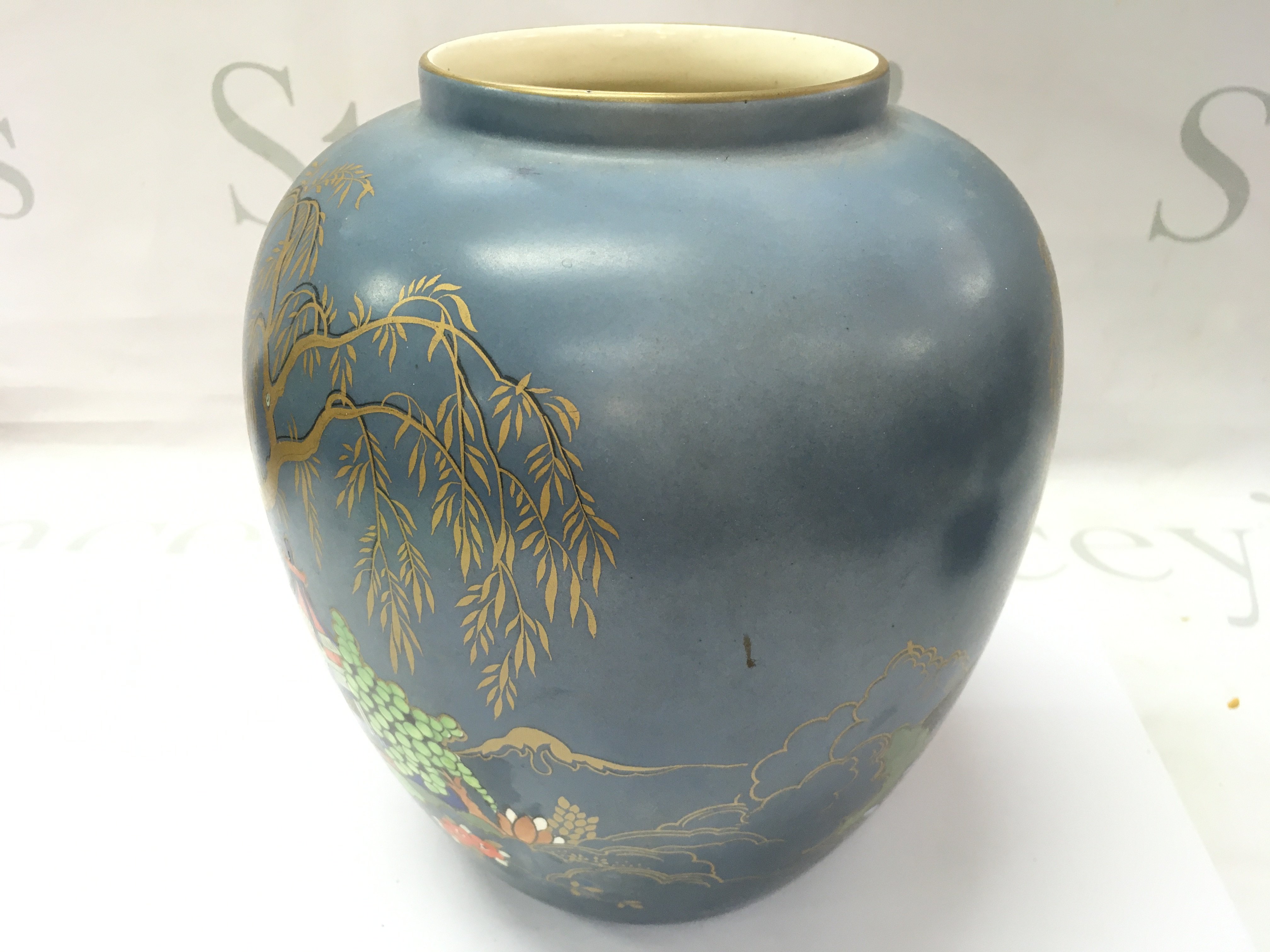 An Art Deco vase with an oriental painted scene. 20cm tall.- NO RESERVE