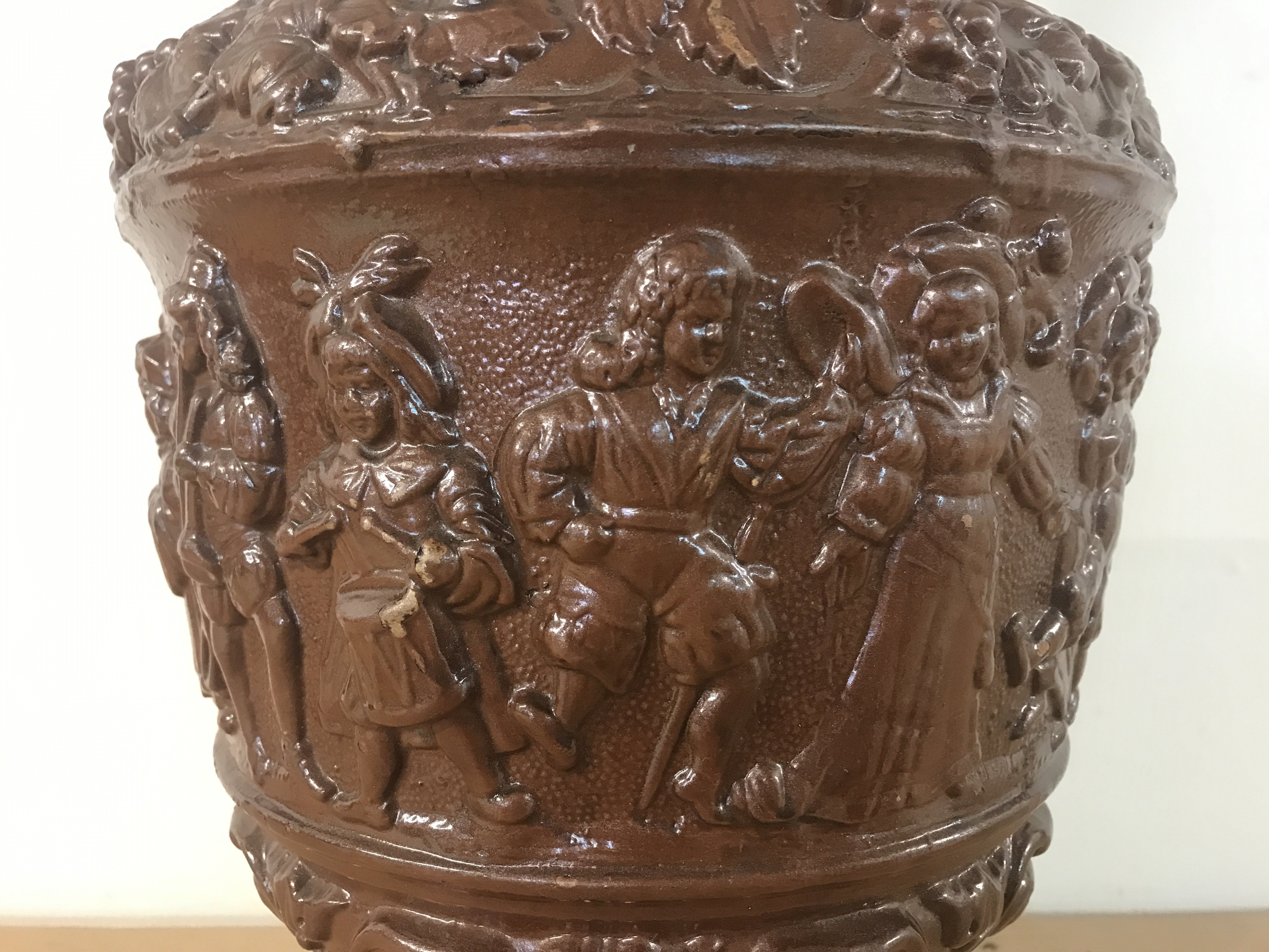A German pottery ewer, Metilach style decorated with classical style figures and animals. 53cm tall approximately .This lot cannot be posted- NO RESERVE