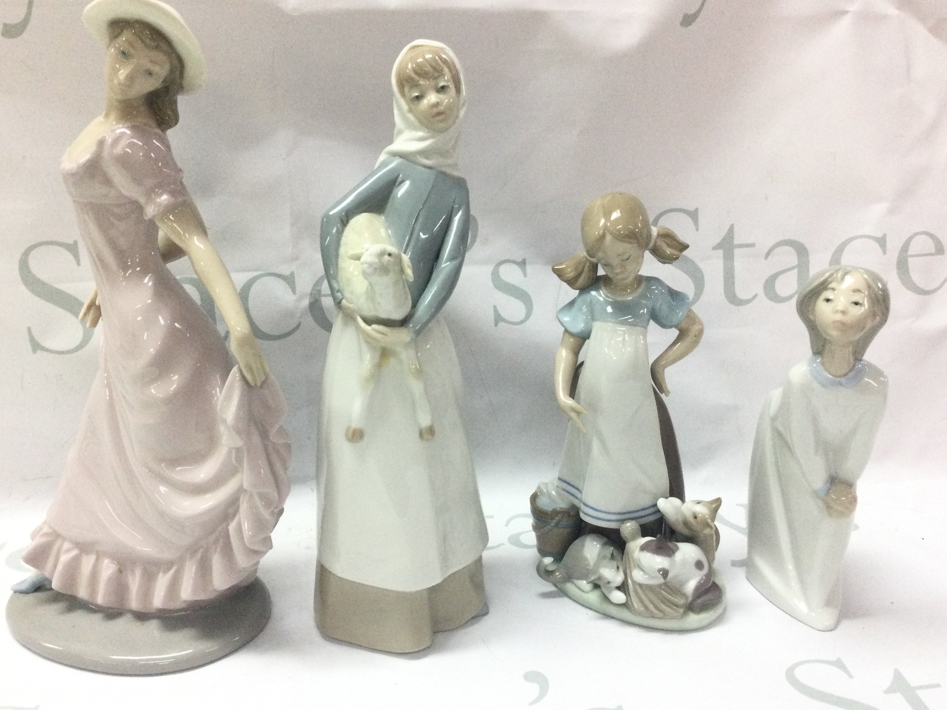 Three Lladro porcelain figures and a zaphir Figure . This lot cannot be posted