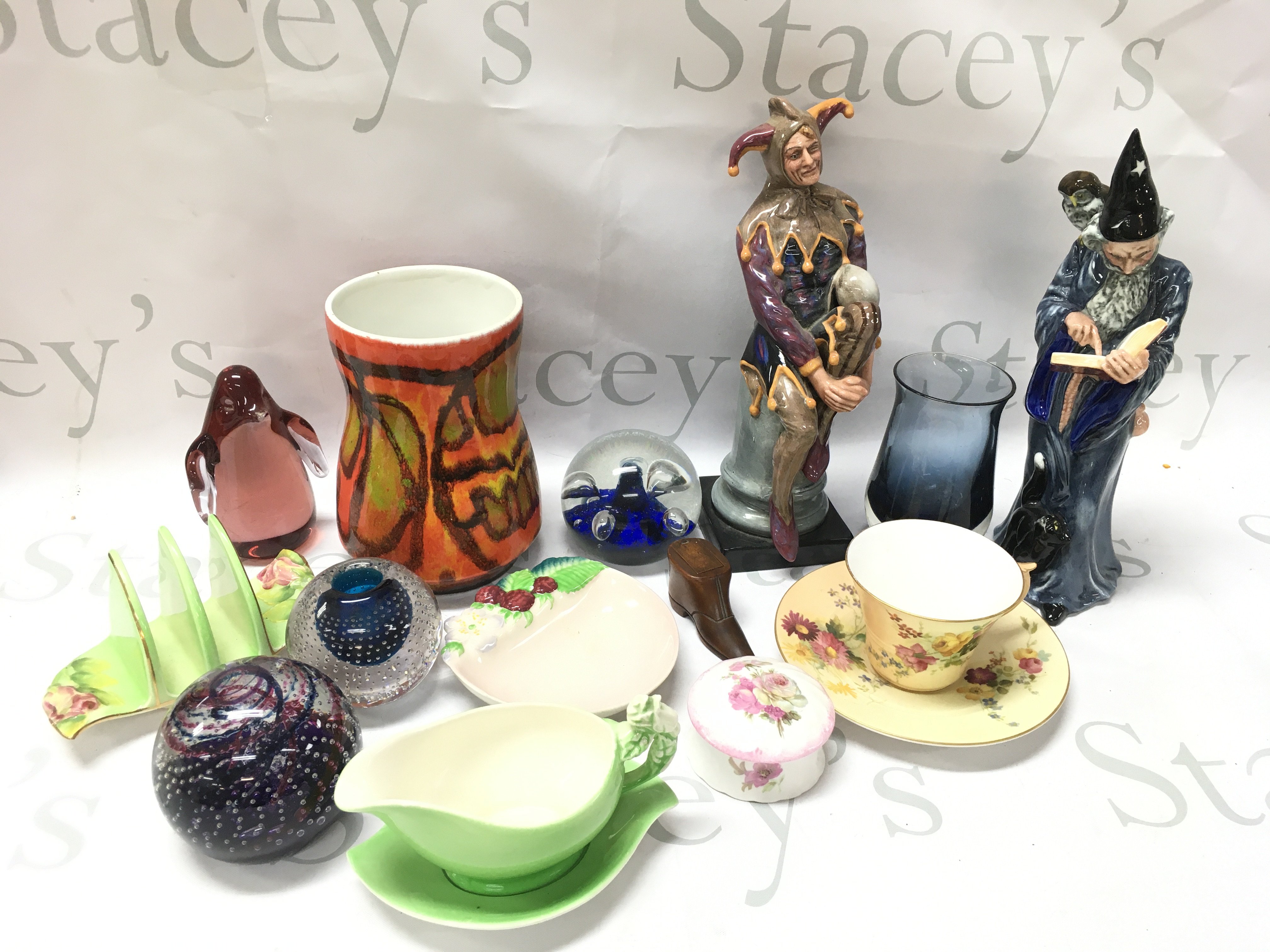 A collection of various ceramics including Royal Doulton Wizard and Jester figures, Royal Worcester cup and saucer, paperweights, Poole vase, Royal Winton Etc . This lot cannot be posted