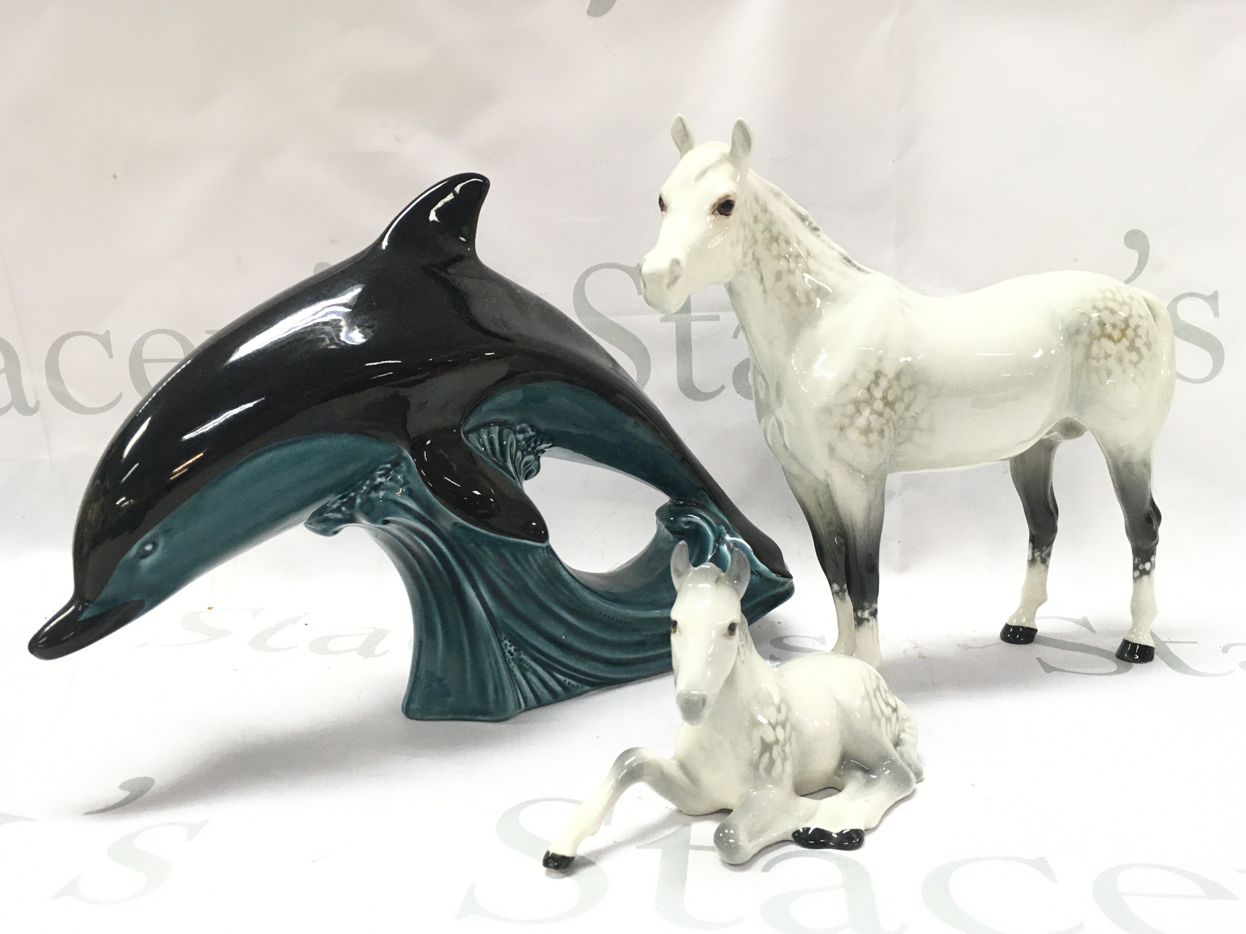 Beswick horses and a Poole dolphin. This lot cannot be posted