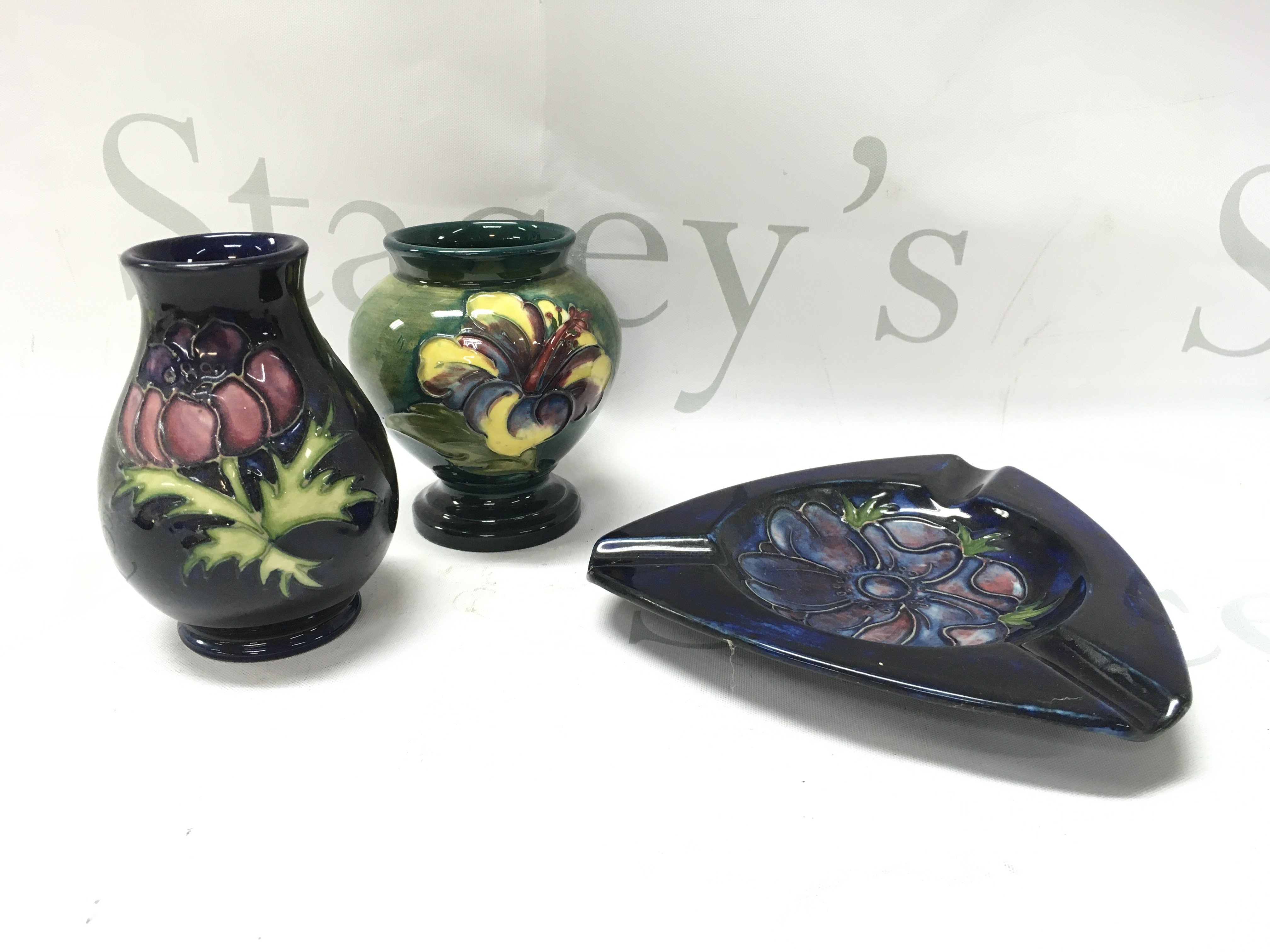 Moorcroft small vases (10cm tall) and an ashtray (13cm wide). This lot cannot be posted