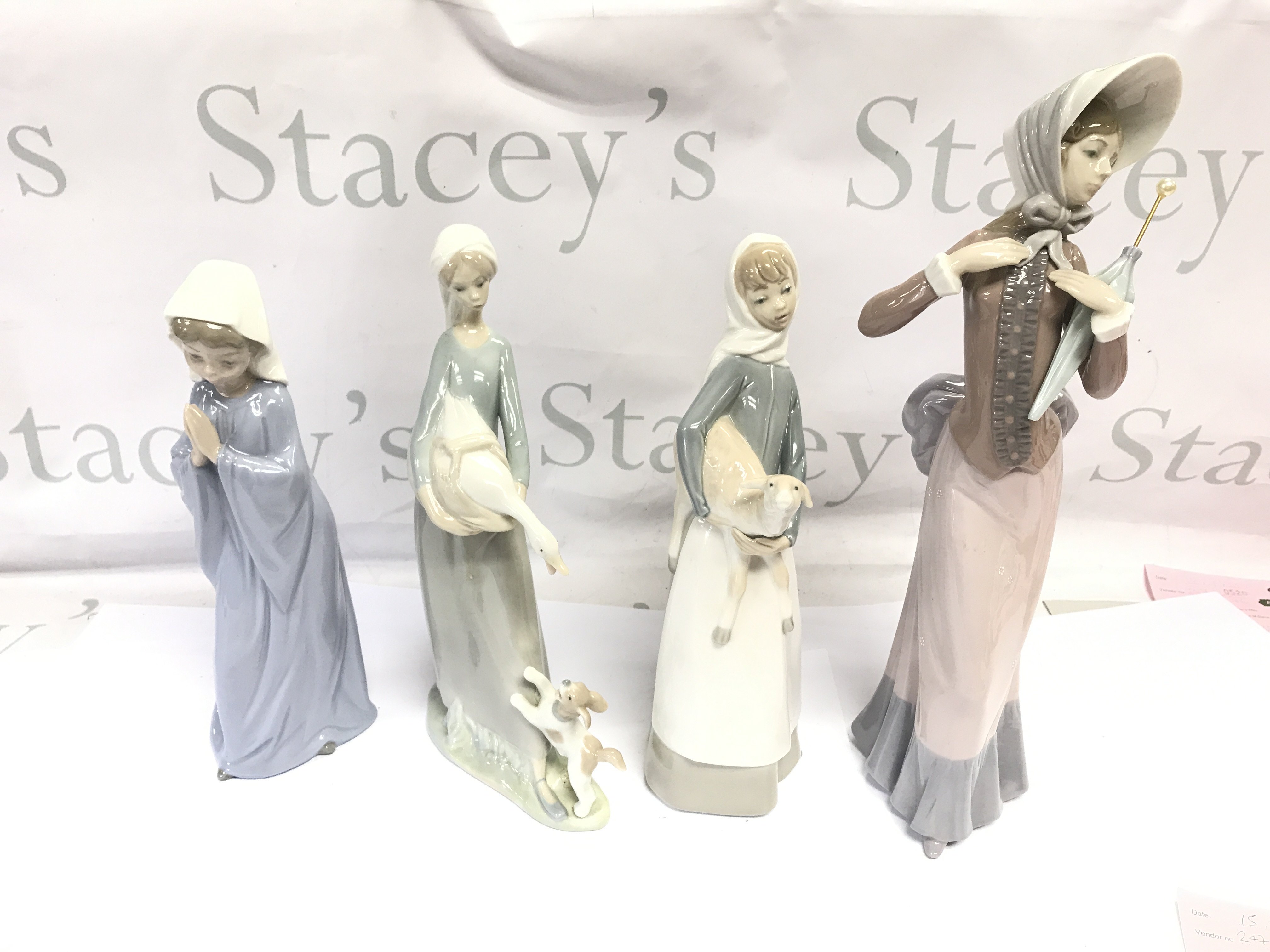 Two Lladro figures and two Nao figures. No damage noted. Postage D