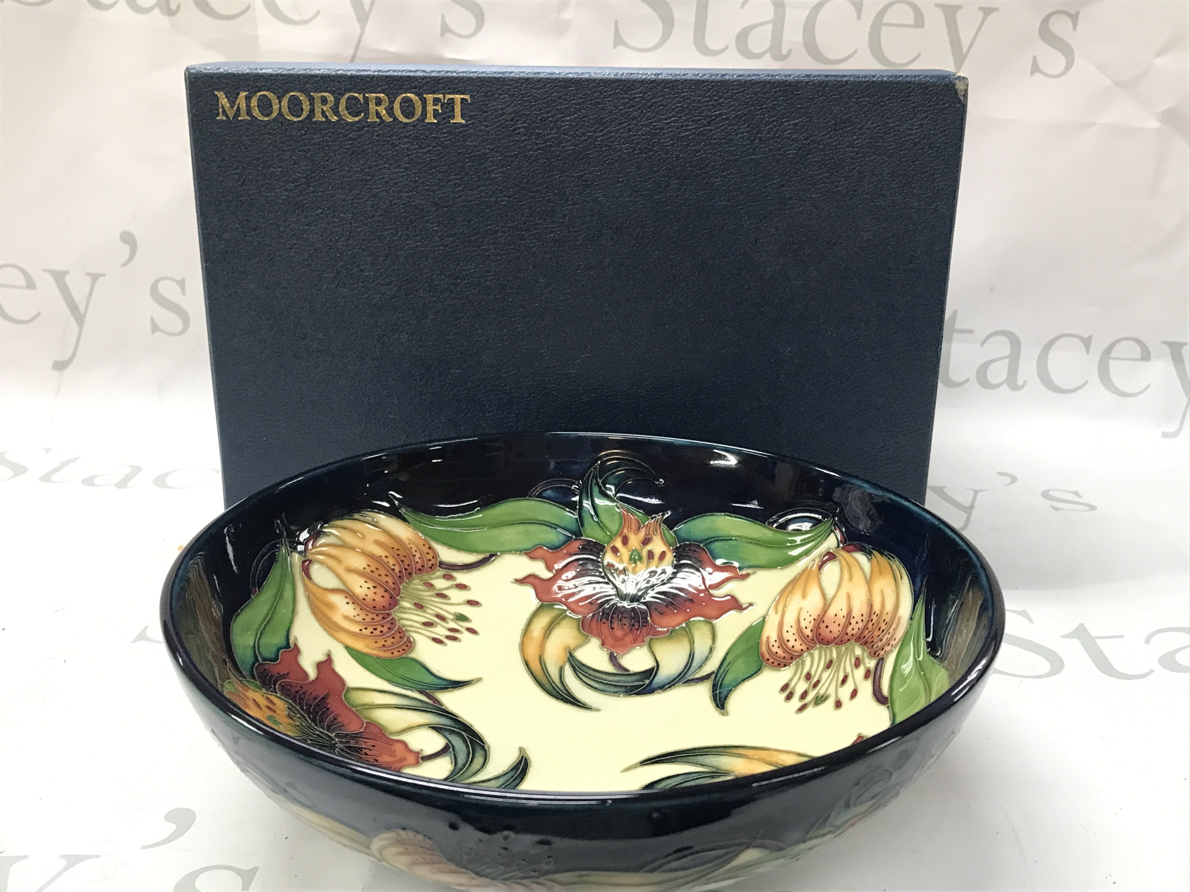 Moorcroft Anna Lily bowl, circa 1998 . No obvious damage or restoration. Crazing seen. 26cm wide 8.5cm tall. This lot cannot be posted