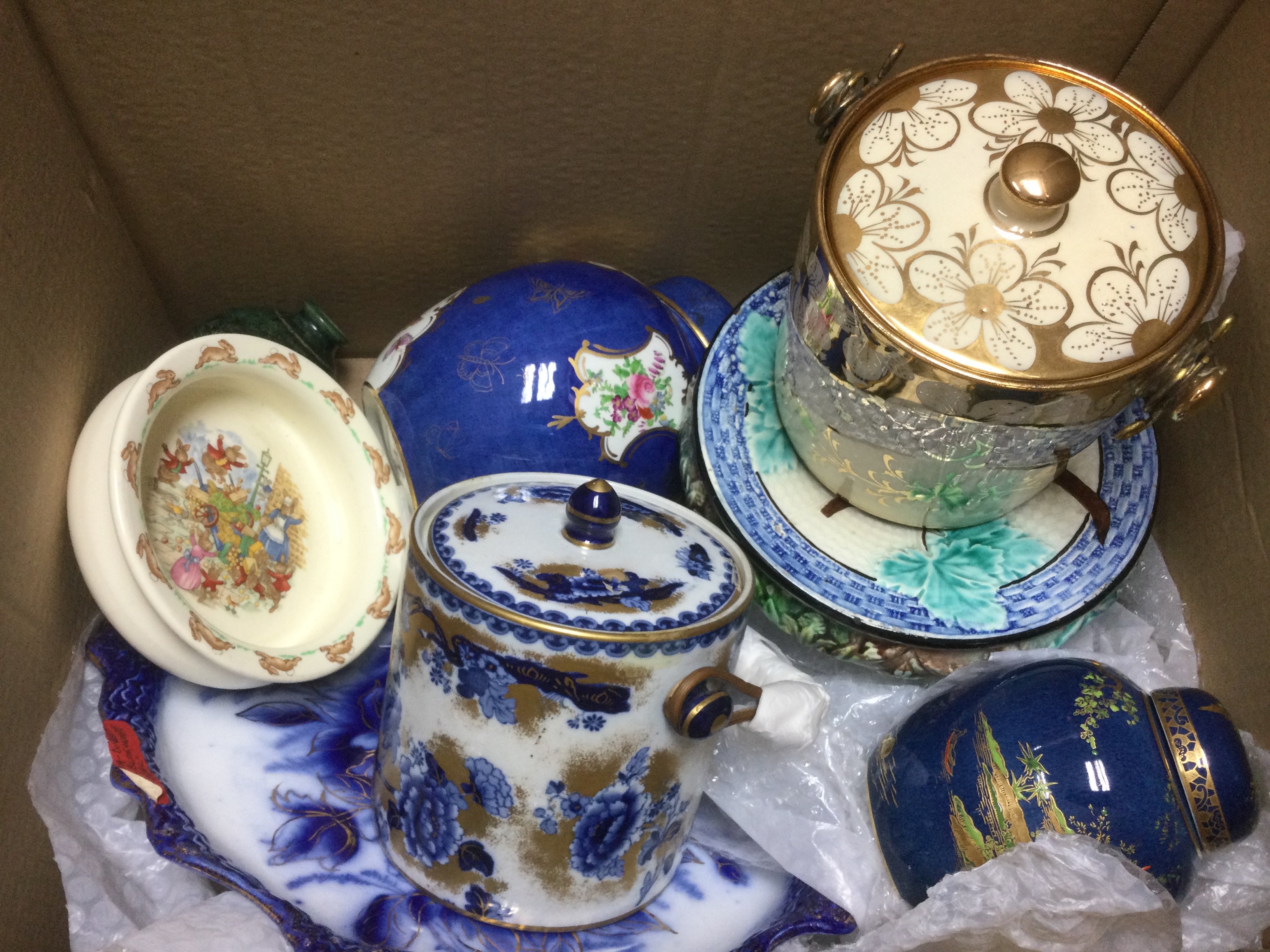 Two boxes of ceramics including blue and white plates, a Carltonware ginger jar and cover, biscuit barrels etc.