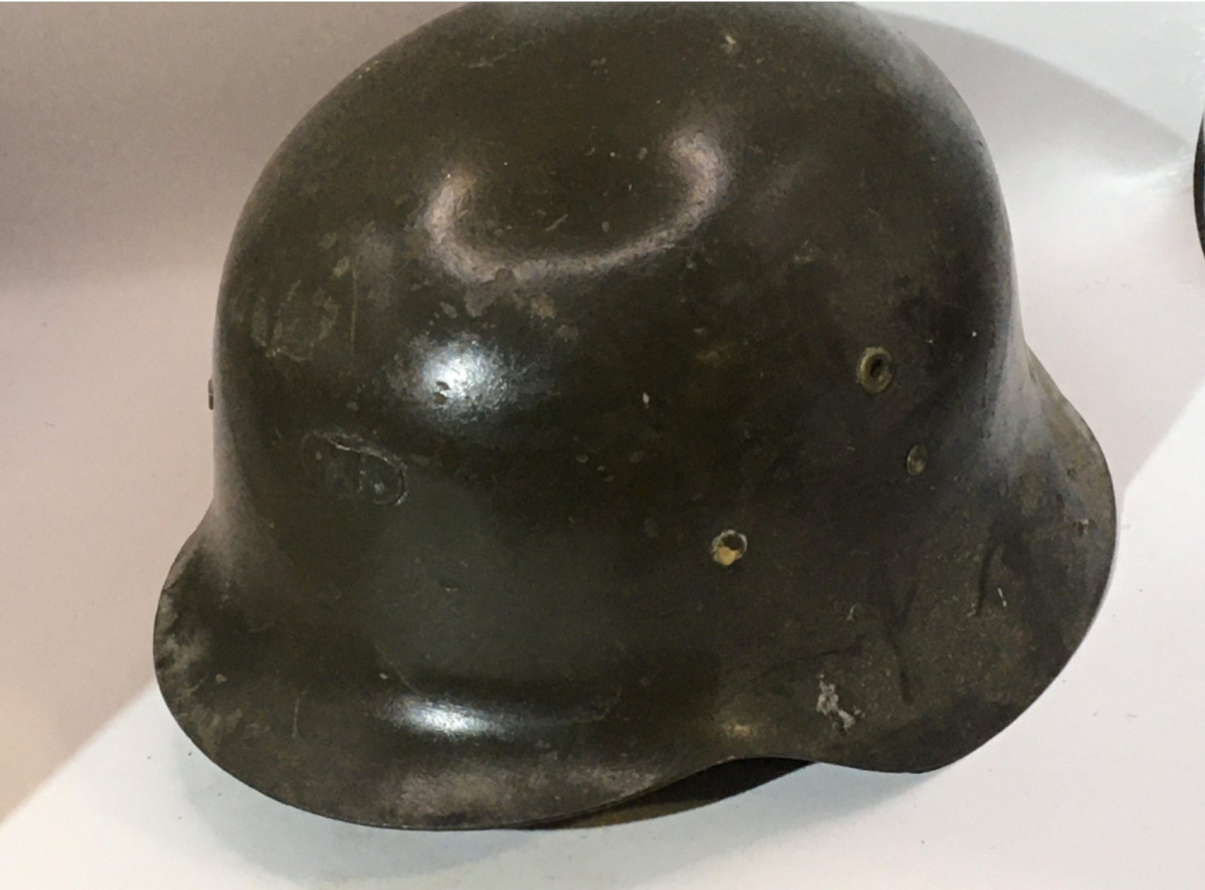 A German Third Reich M42 pattern helmet green with attached bracket above the peak thick cut leather liner. No obvious stamp marks.