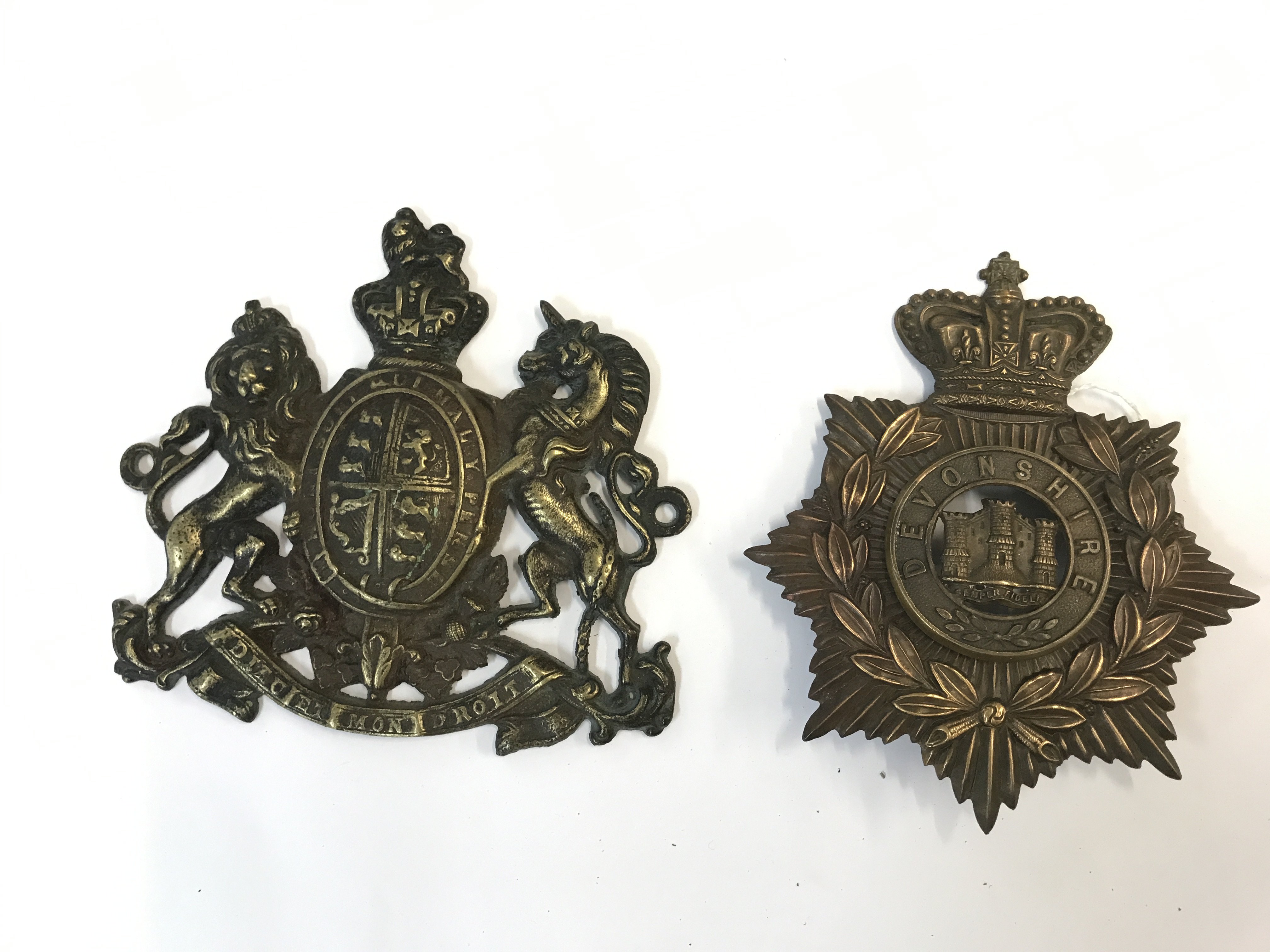 Devonshire helmet plate and a brass coat of arms plate . Postage category B