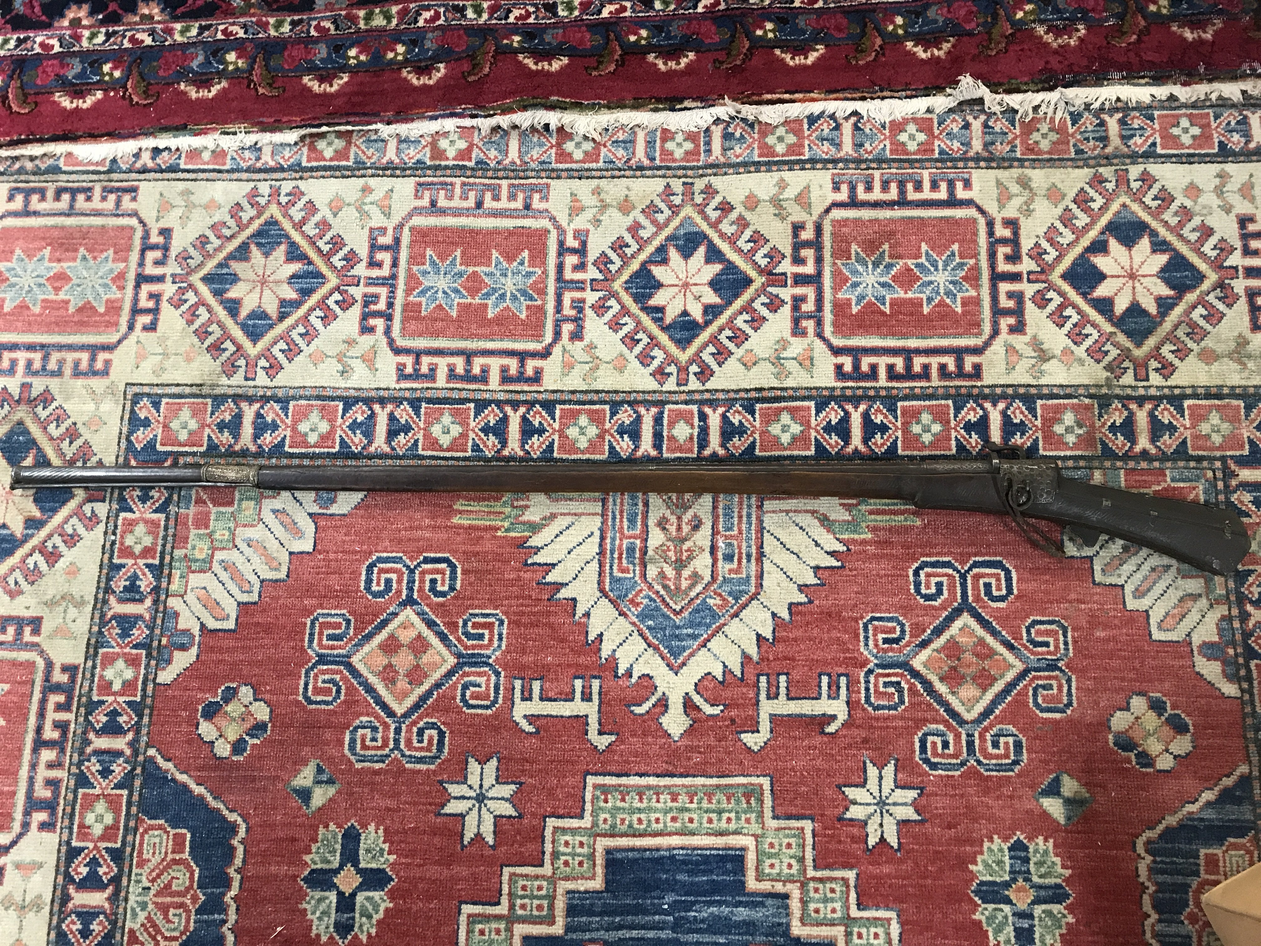 An Afghan or Indian Jazail Rifle with matchlock action applied metal ornamentation.