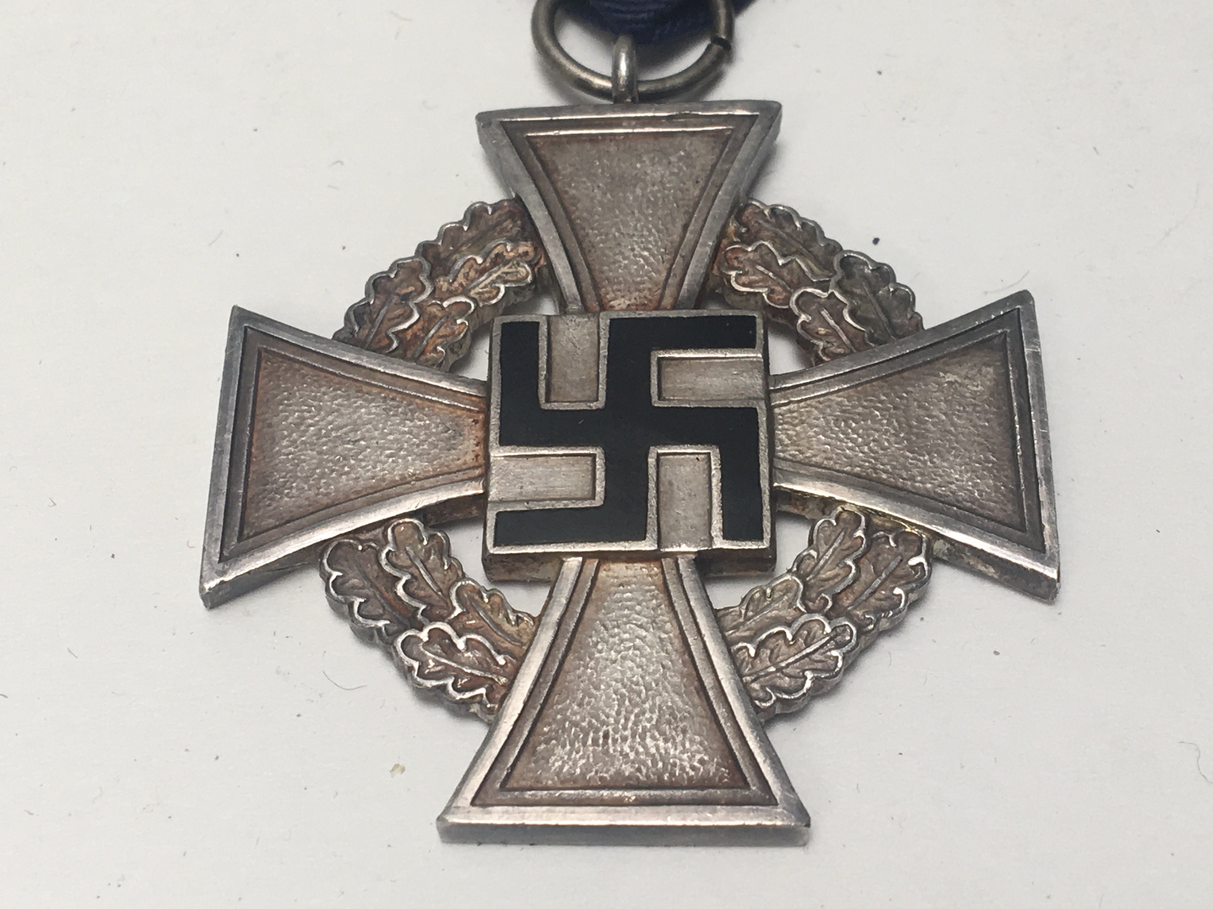 A German Third Reich SS long service medal with black enamel and blur ribbon