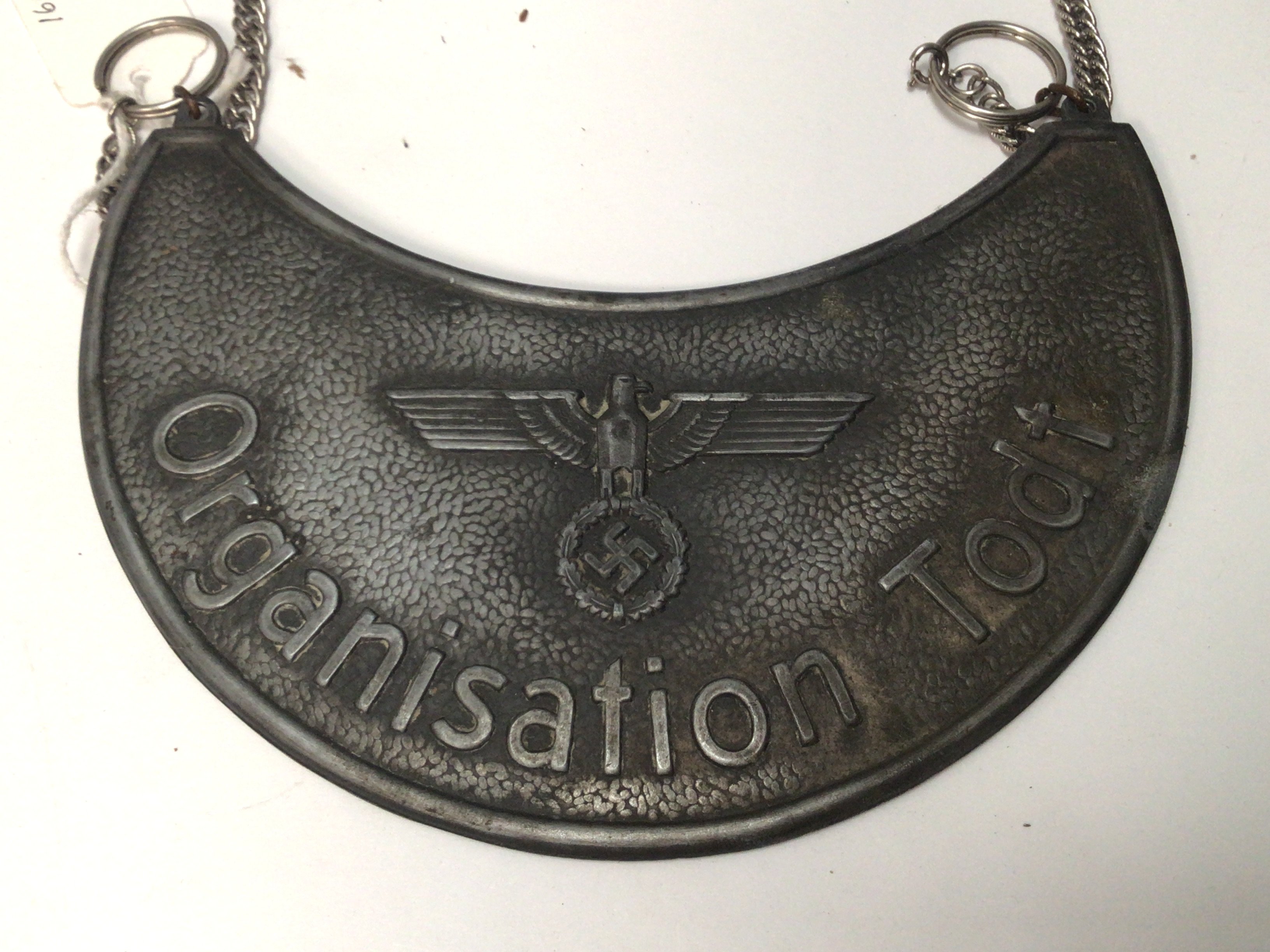 A rare German Gorget: a WW2 NAZI 'TODT' ORGANISATION Gorget. Crescent moon shape with blue felt backing & hanging loops later chain. Vendors comments found in Jersey.