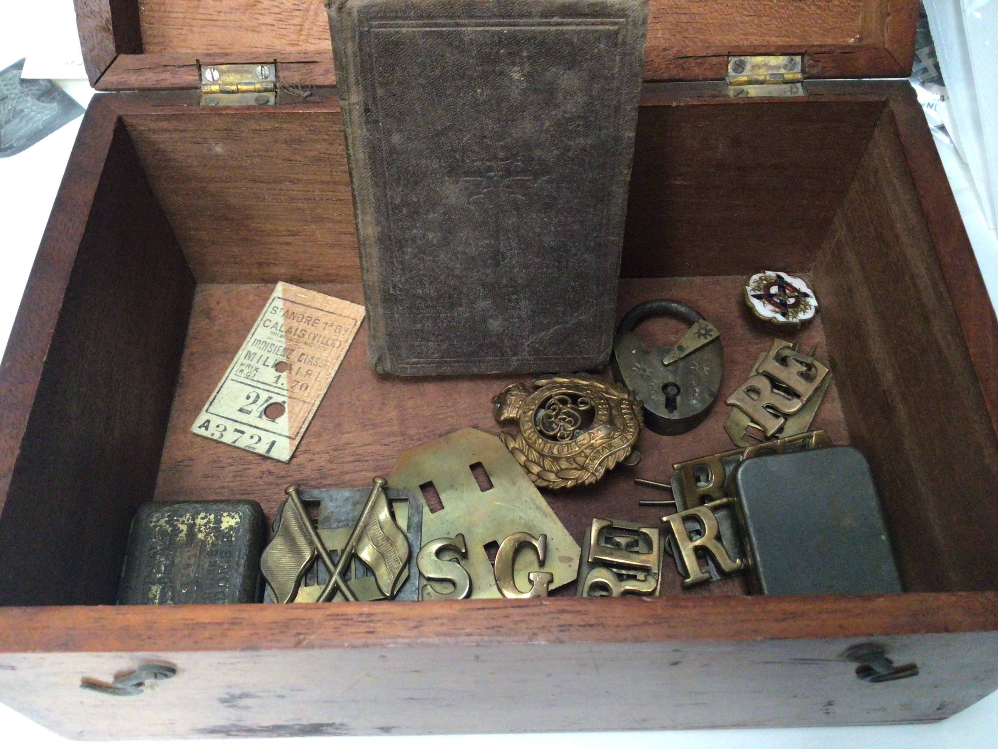 A box containing British military badges.