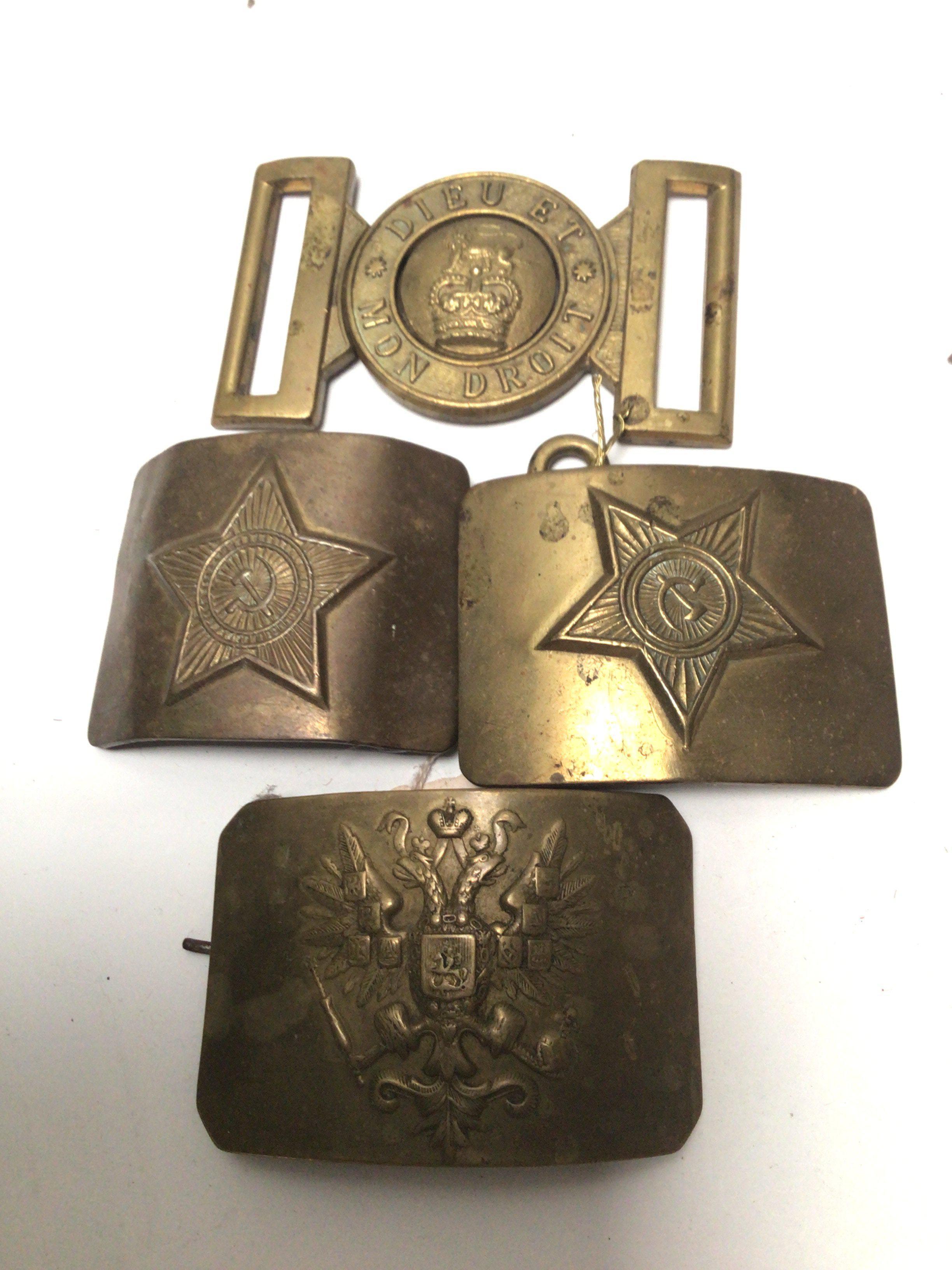 Three Russian brass belt buckles and a British military belt buckle (4)