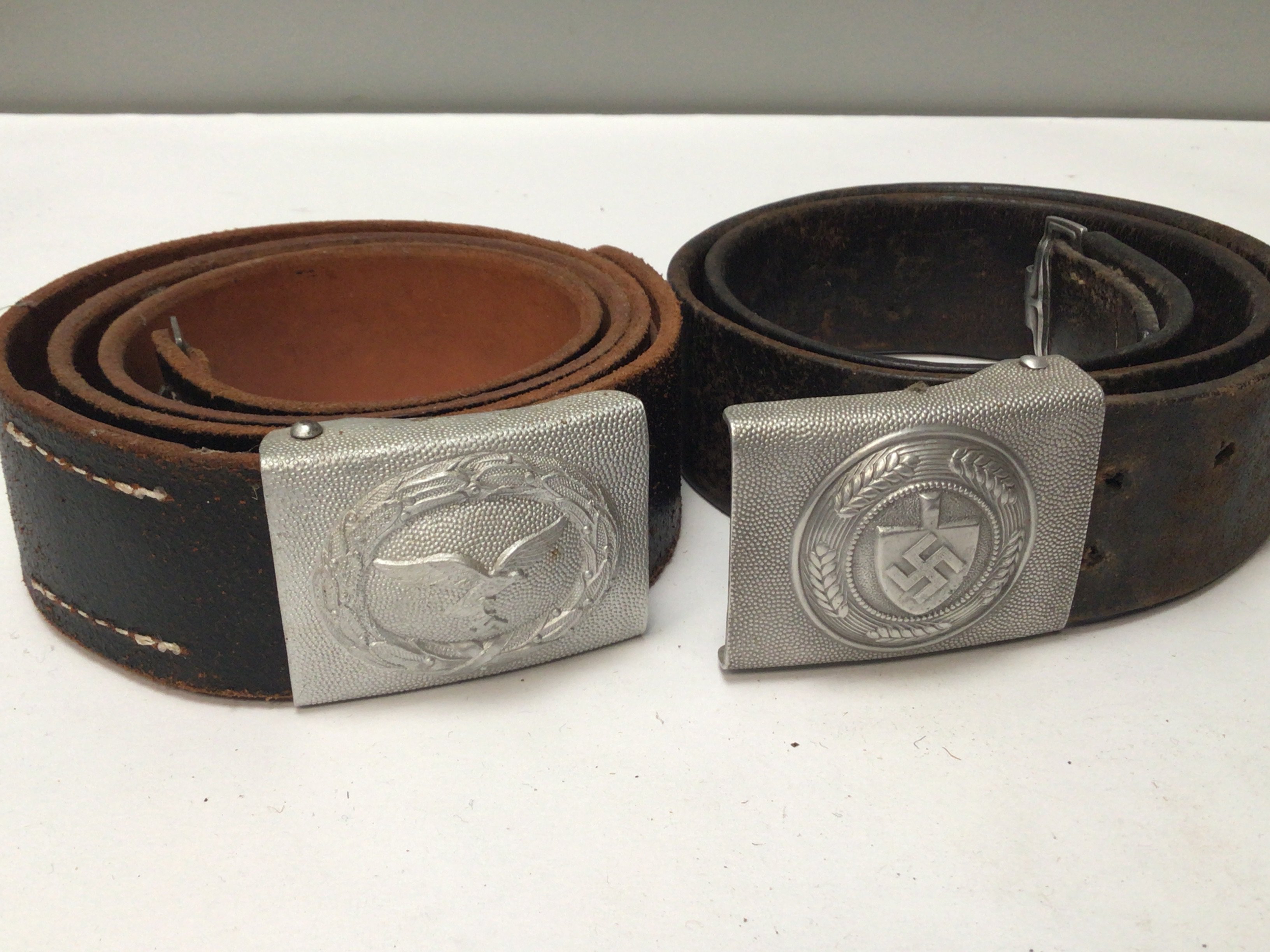 Two German Third Reich belt buckles with attached leather belts including RAD the German National Labour Service and. Luftwaffe (2)
