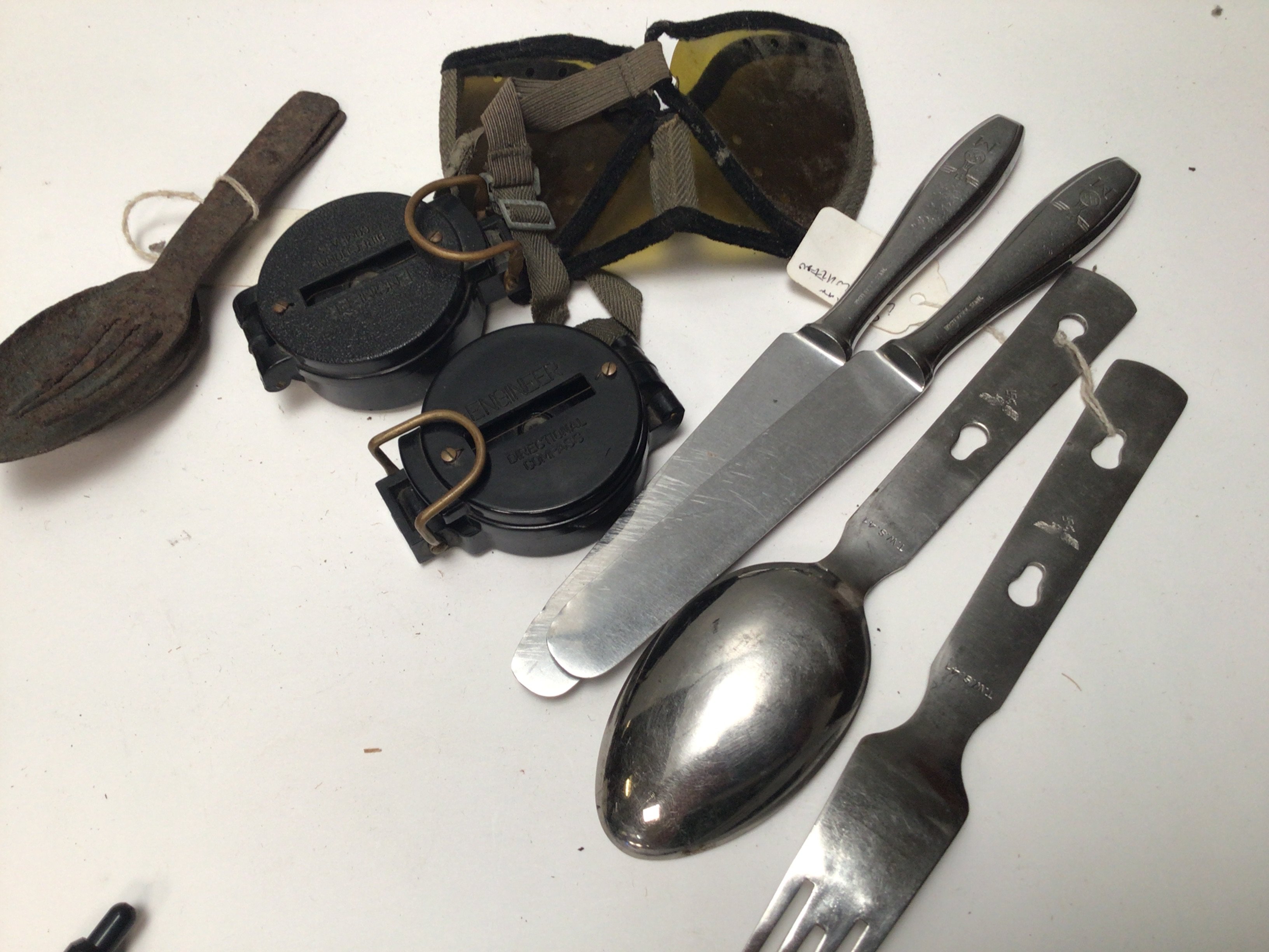A Collection of German Third Reich military issue cutlery with German marks two compasses and other oddments.