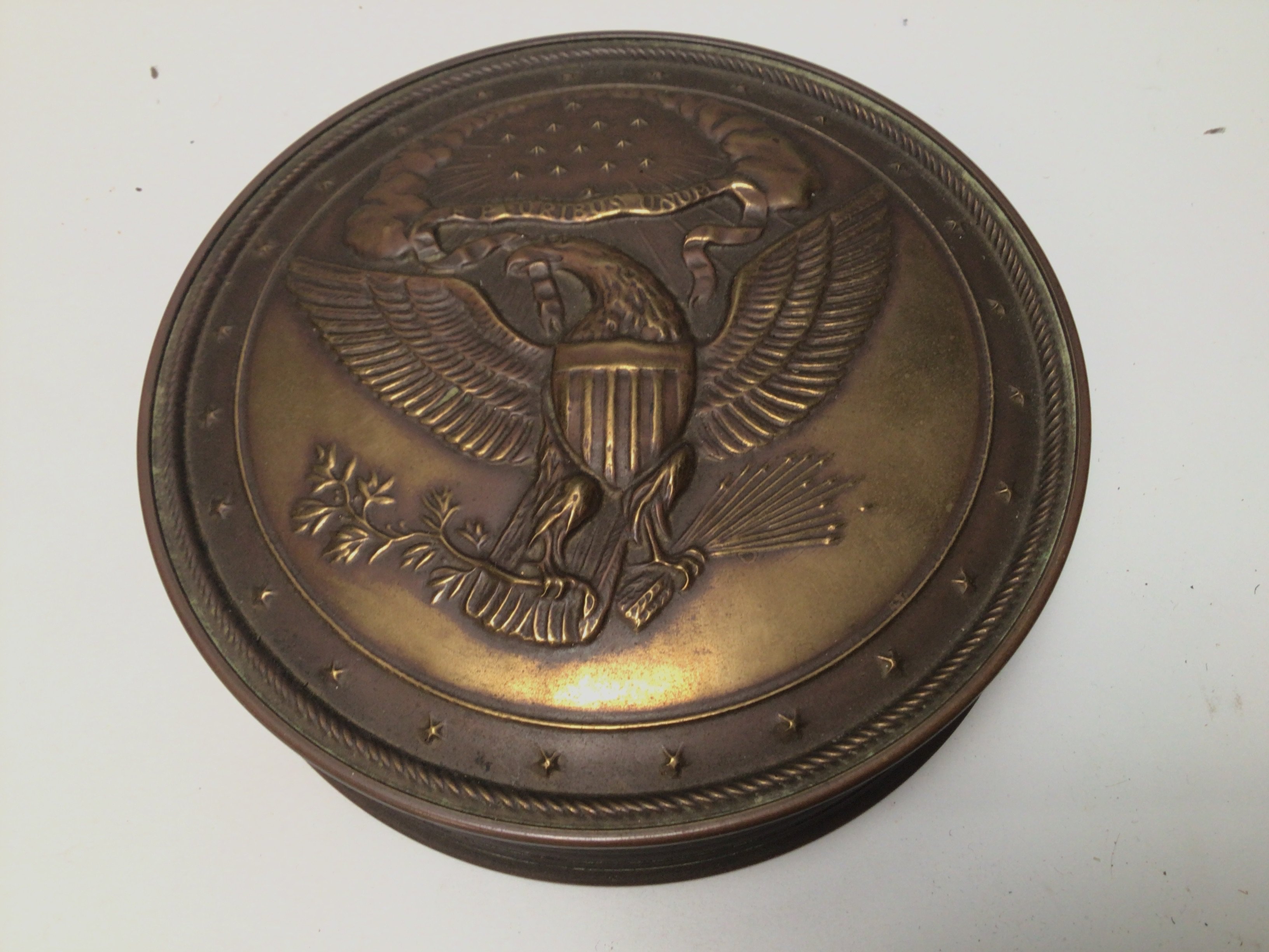 An American brass container of circular shape.
