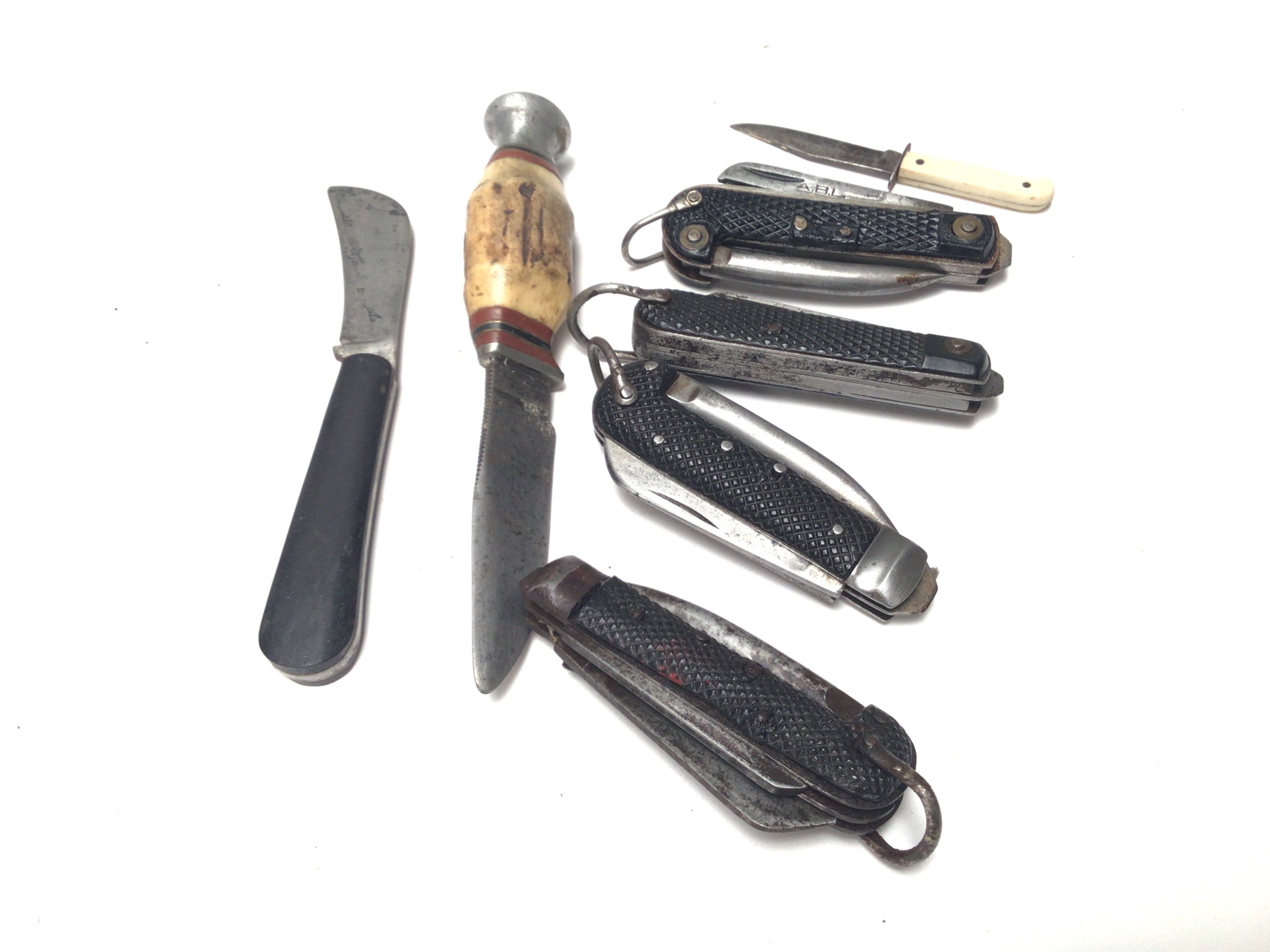 A collection of Vintage folding multi purpose pocket knifes a small vintage hunting Knife with a horn handle.