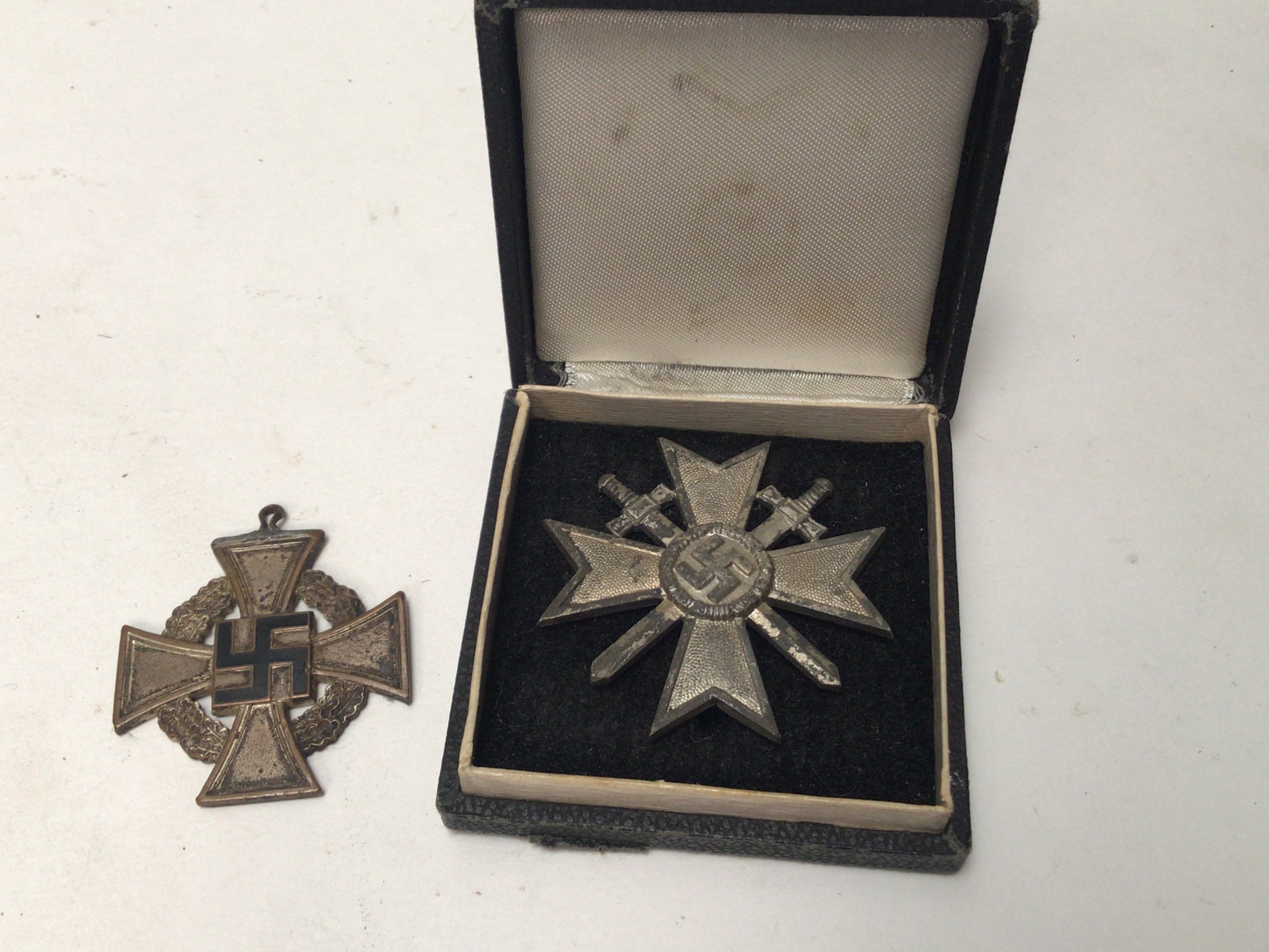 A German Third Reich war merit cross first class in a fitted box pin stamped LM6 with further small symbol. and a 25year long service cross