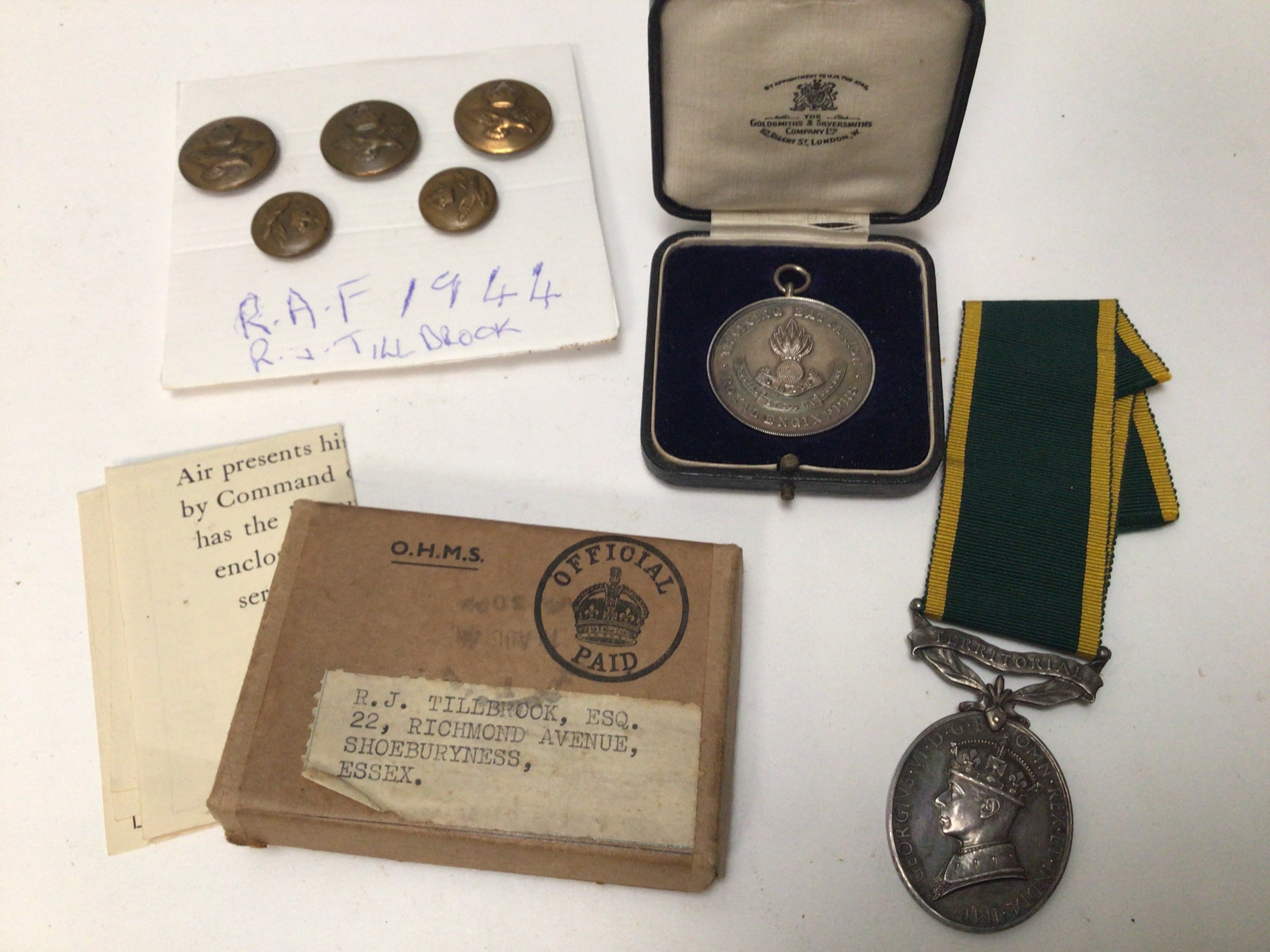 A George VI Territorial efficient service medal Royal Artillery a Royla Engineers medal in a fitted box A war medal awarded to RJ Tillbrook Shoeburyness and a set of buttons