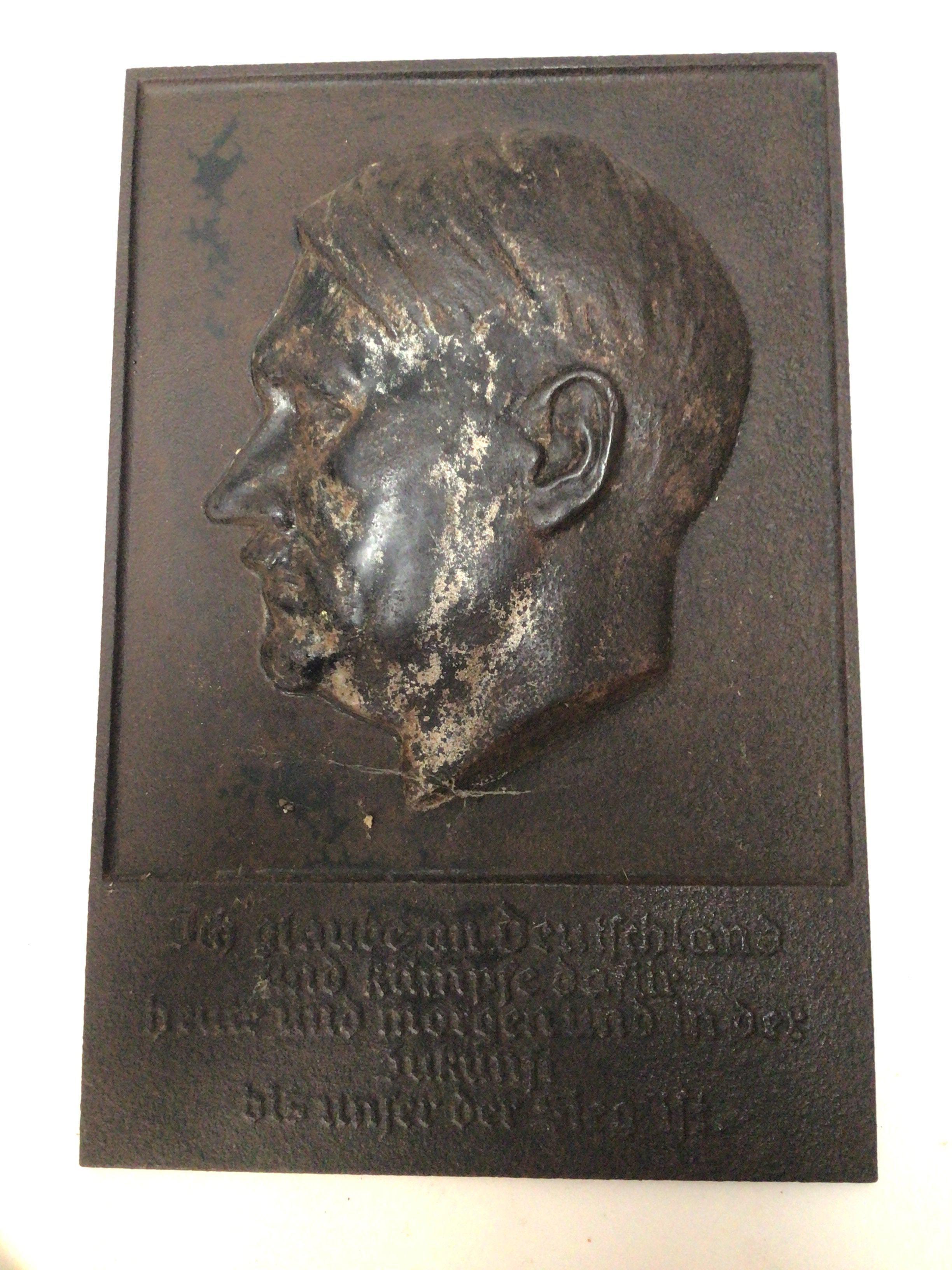A cast metal plaque depicting Adolf Hitler and with the German inscription I believe in Germany a new beginning 32x21cm