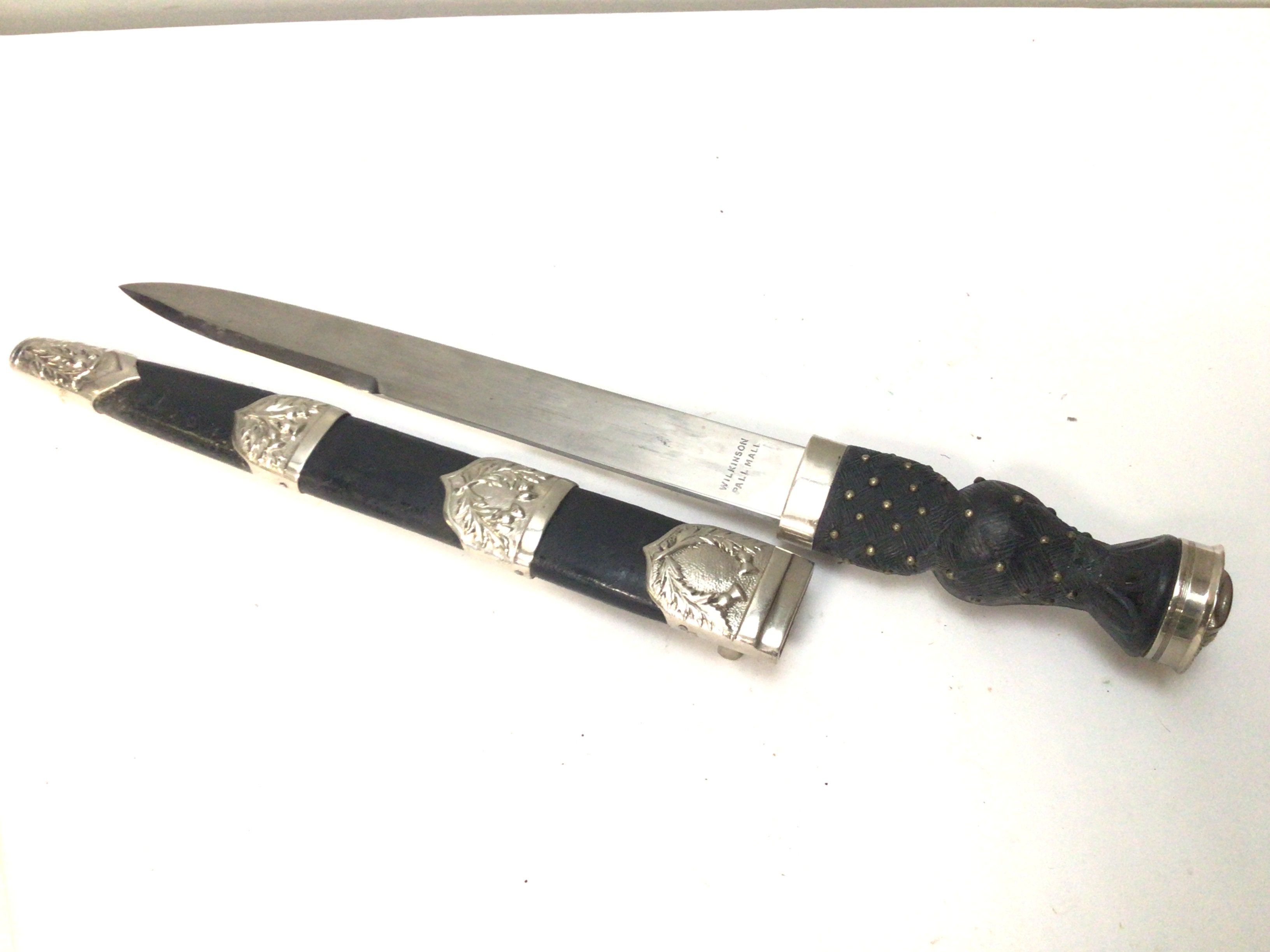 A Scottish Dirk maker Wilkinson Pall Mall the blade with a military symbol. Raised crown pommel.