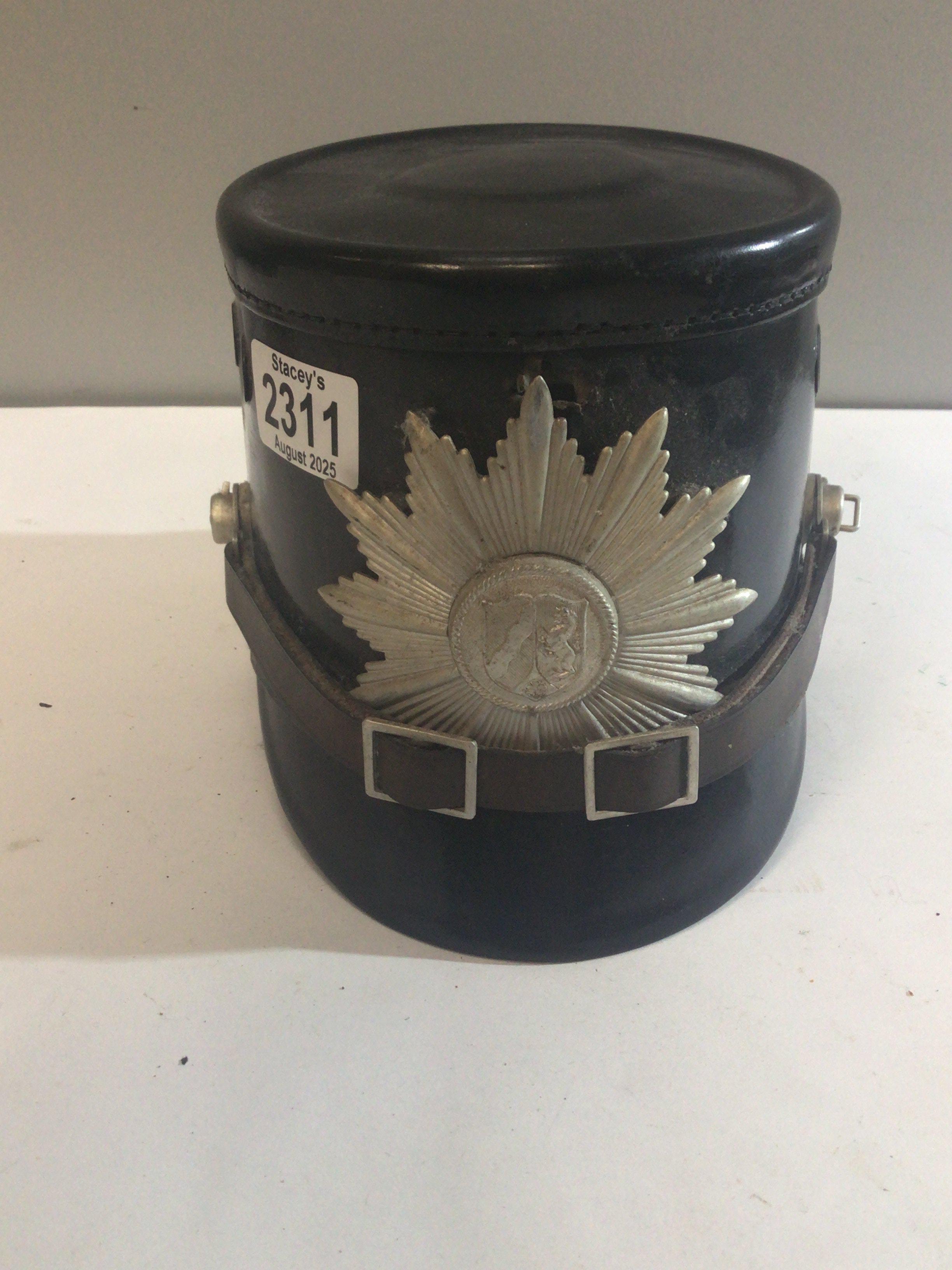 A Continental leather finish helmet with applied badge the interior of the hat with label.